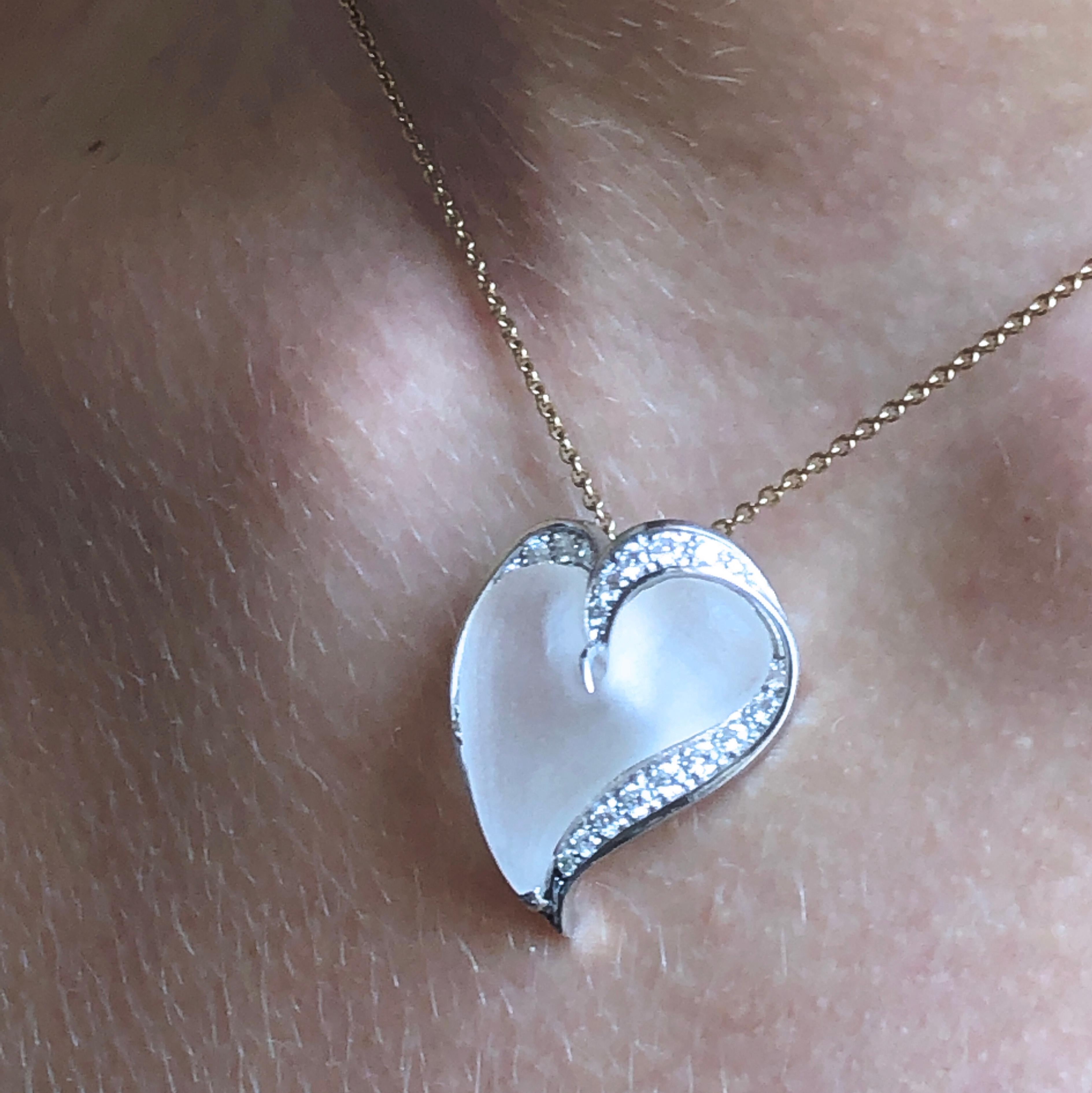 A very chic, timeless, yet not traditional Heart Pendant featuring a natural rock crystal hand inlaid Heart in a 0.56 Carat White Diamond(D-E, IF) handcrafted platinum setting. 

This heart has been selected by Platinum Guild International as one of