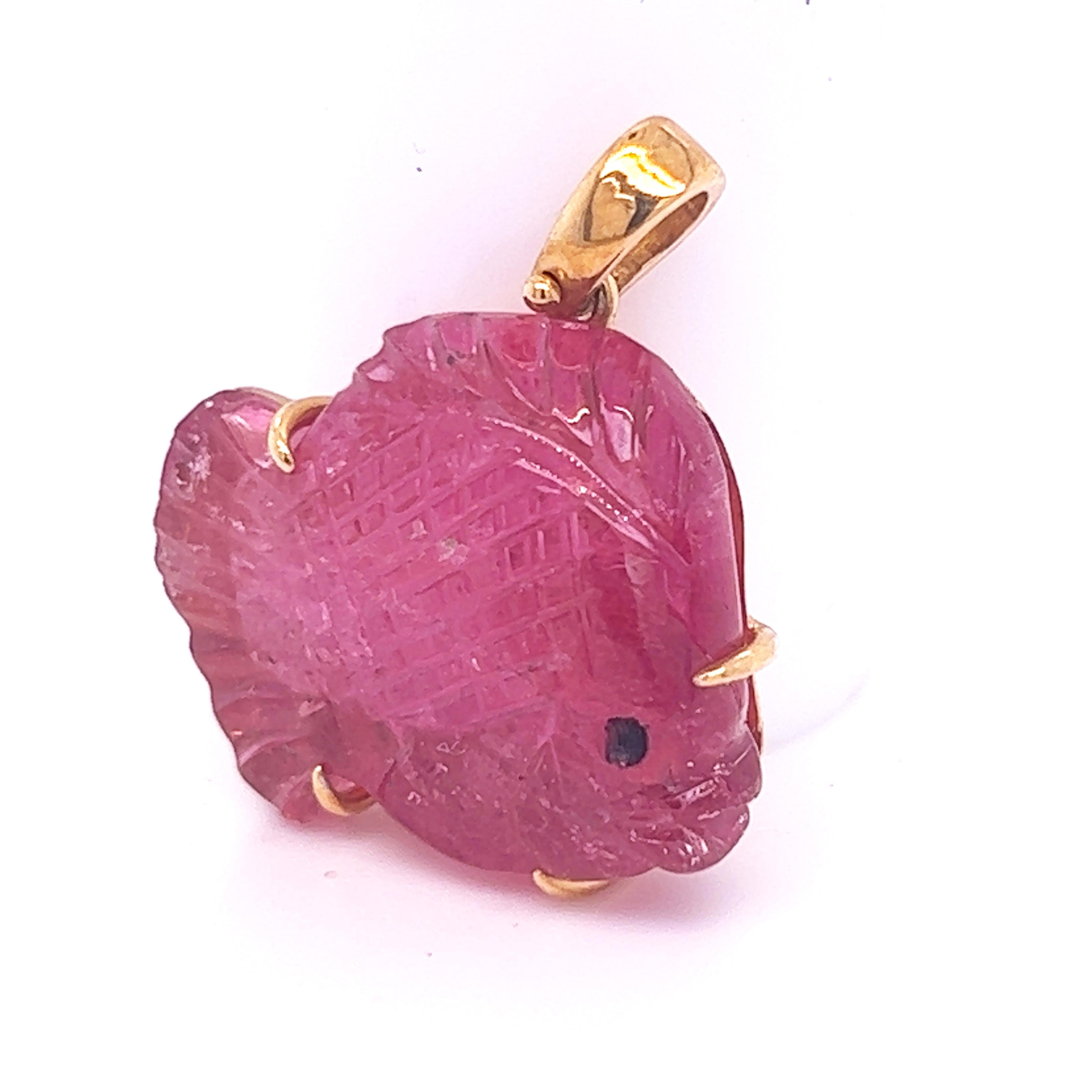 One-of-a-kind, chic pendant featuring an unique 12Kt pink tourmaline, beautifully fish shaped.
The natural stone, hand inlaid and hand engraved in Germany was carefully set in 18k yellow gold in our atelier. A long dark leather ribbon is