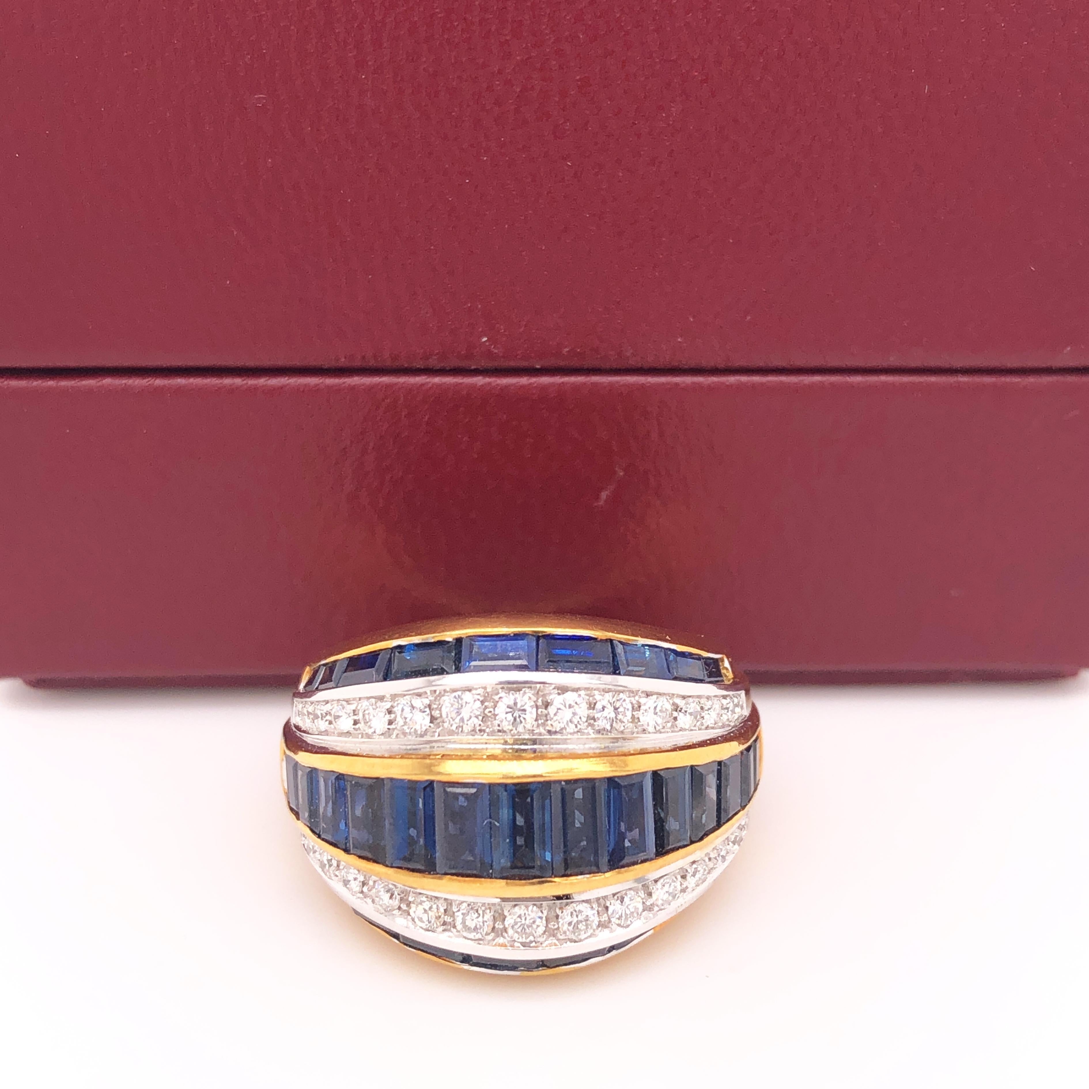 One-of-a-kind, Original 1980, Sumptuous, Unique yet Timeless Cocktail Ring Featuring 5.33Kt Natural Blue Sapphire Baguette Cut, 0.53Kt Top Quality White Diamond(D-E, VVs1) in a White and Yellow 18Kt Gold Setting.
In Our Fitted Burgundy Leather