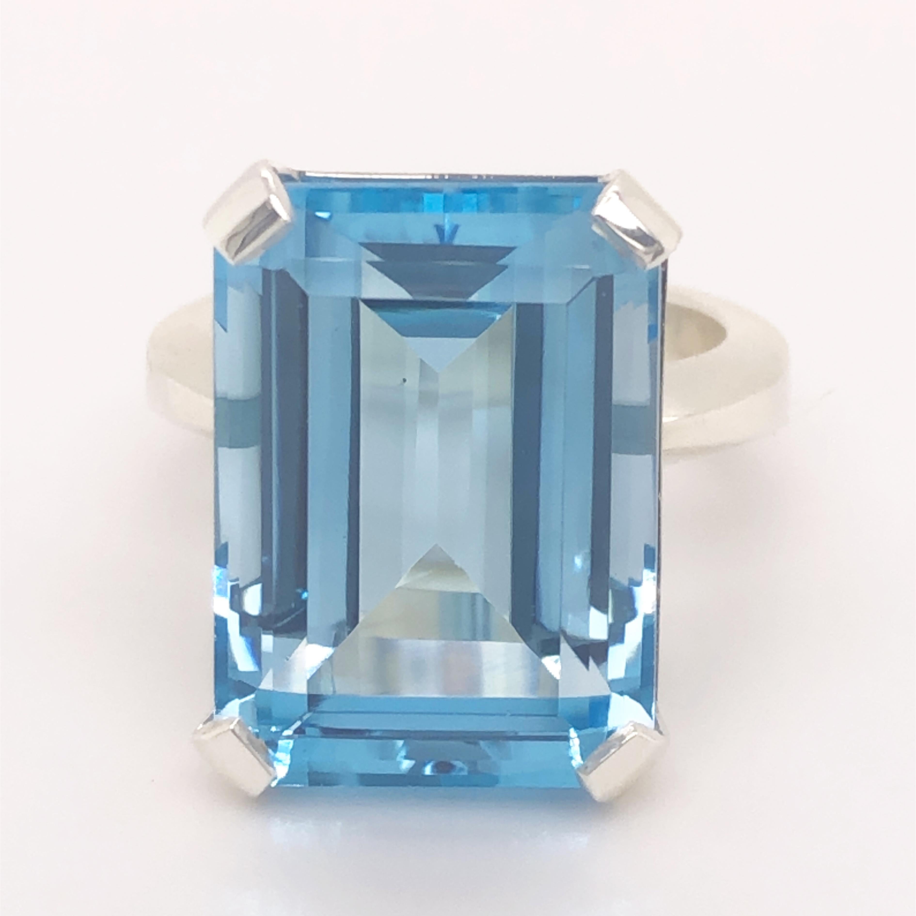 One-of-a-kind 20.2 Carat Emerald Cut Natural Light Blue Topaz(0.708inches lenght 0.508inches width, 18.1x13.30mm) in a Chic yet Timeless mirror Finish Sterling Silver Cocktail Setting.
We are proud to offer this awesome piece perfect as Engagement
