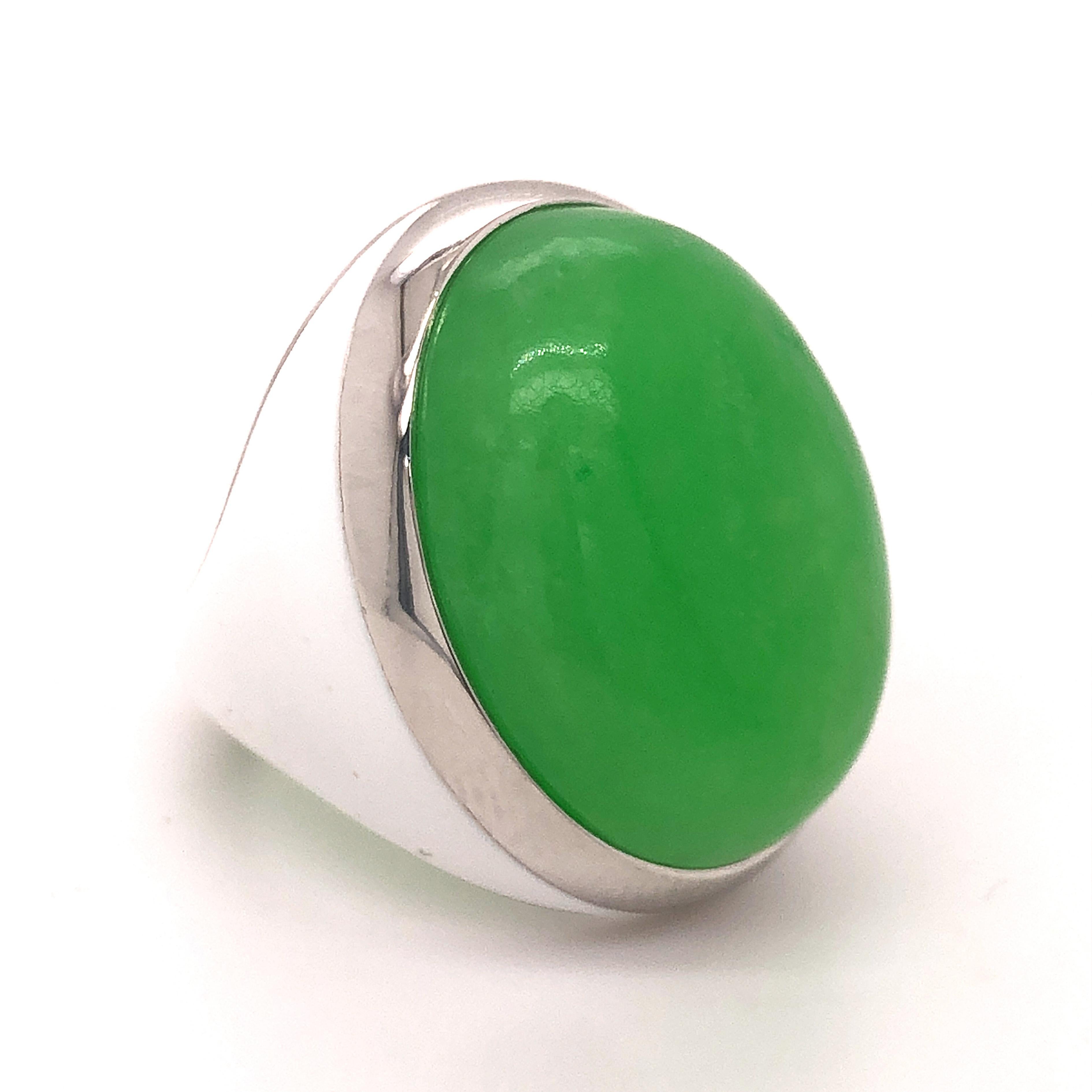 One-of-a-kind, Contemporary, Unique yet Chic Cocktail Ring Featuring a 26.5 Carat Natural Green Jade Cabochon (0.916x0.704in) in a White Hand Enameled Sterling Silver Setting.
The color-changing of the Green Jade's cabochon combined with White Hand