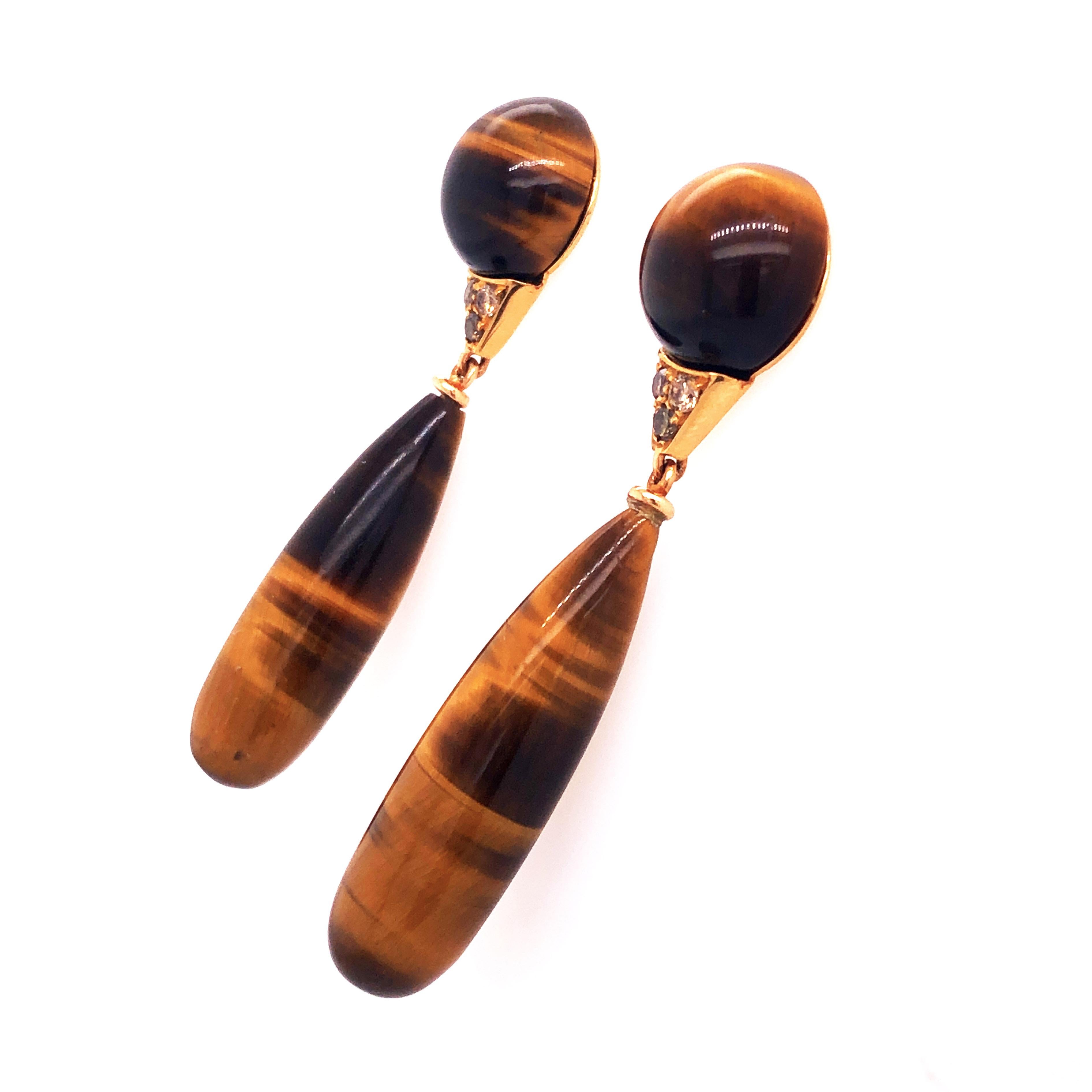 One-of-a-kind Chic yet Timeless Drop Earrings featuring 60.2 Hand Inlaid Natural Round Cabochon and Drop Cut Tiger's Eye in a 0.27 Champagne Diamond 0.131 t oz 18K Yellow Gold Setting.
In our smart fitted box and pouch.

Lenght 2.04 inches,