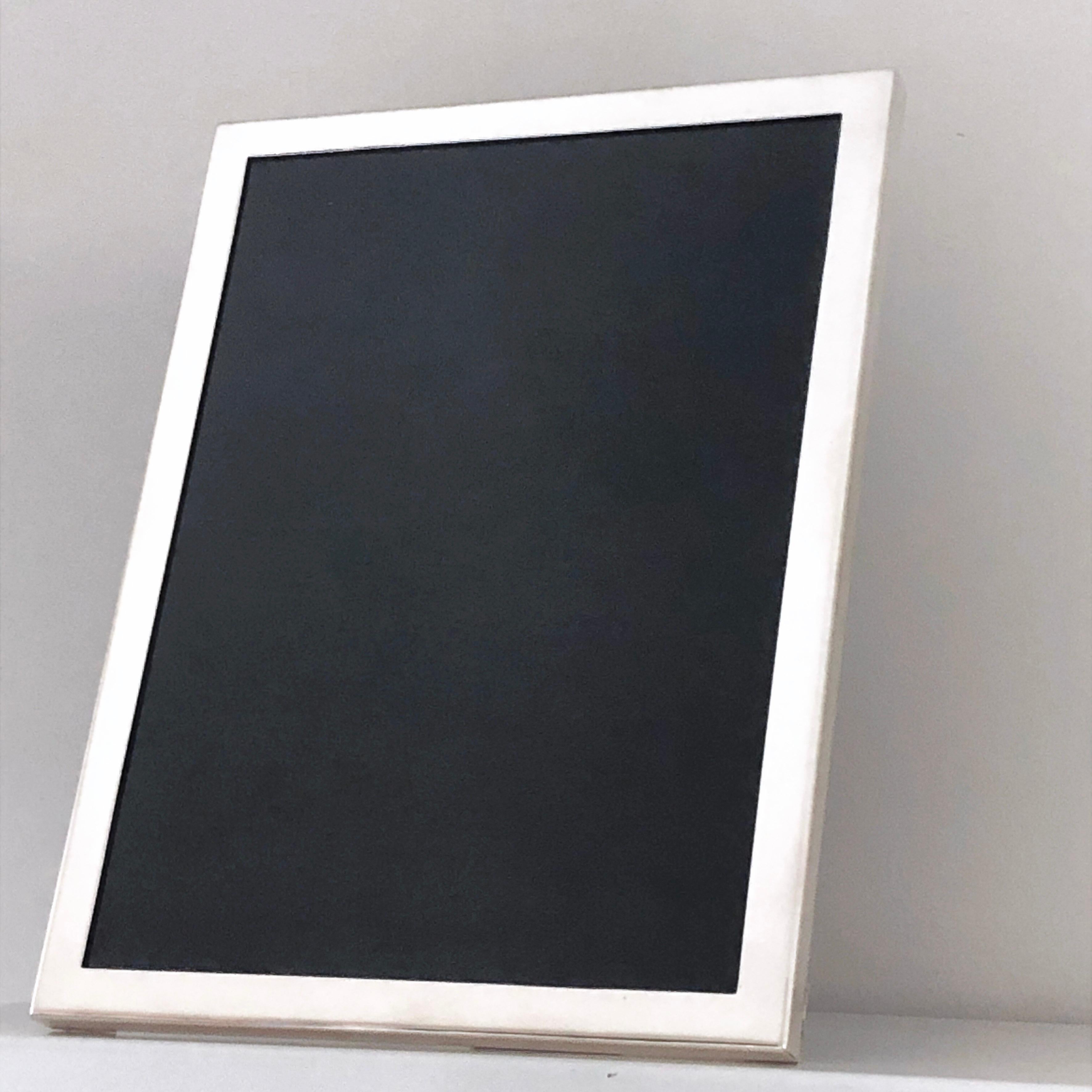 Solid Sterling Silver Chic, Minimal and Elegant, Mirror Finish, Picture Frame, natural hand inlaid Oakwood back. 
This Contemporary yet Timeless Piece Has Been completely Hancrafted by our Expert Goldsmiths.
Frame Size 7.6 in x 10.4 in
Photo Size 7