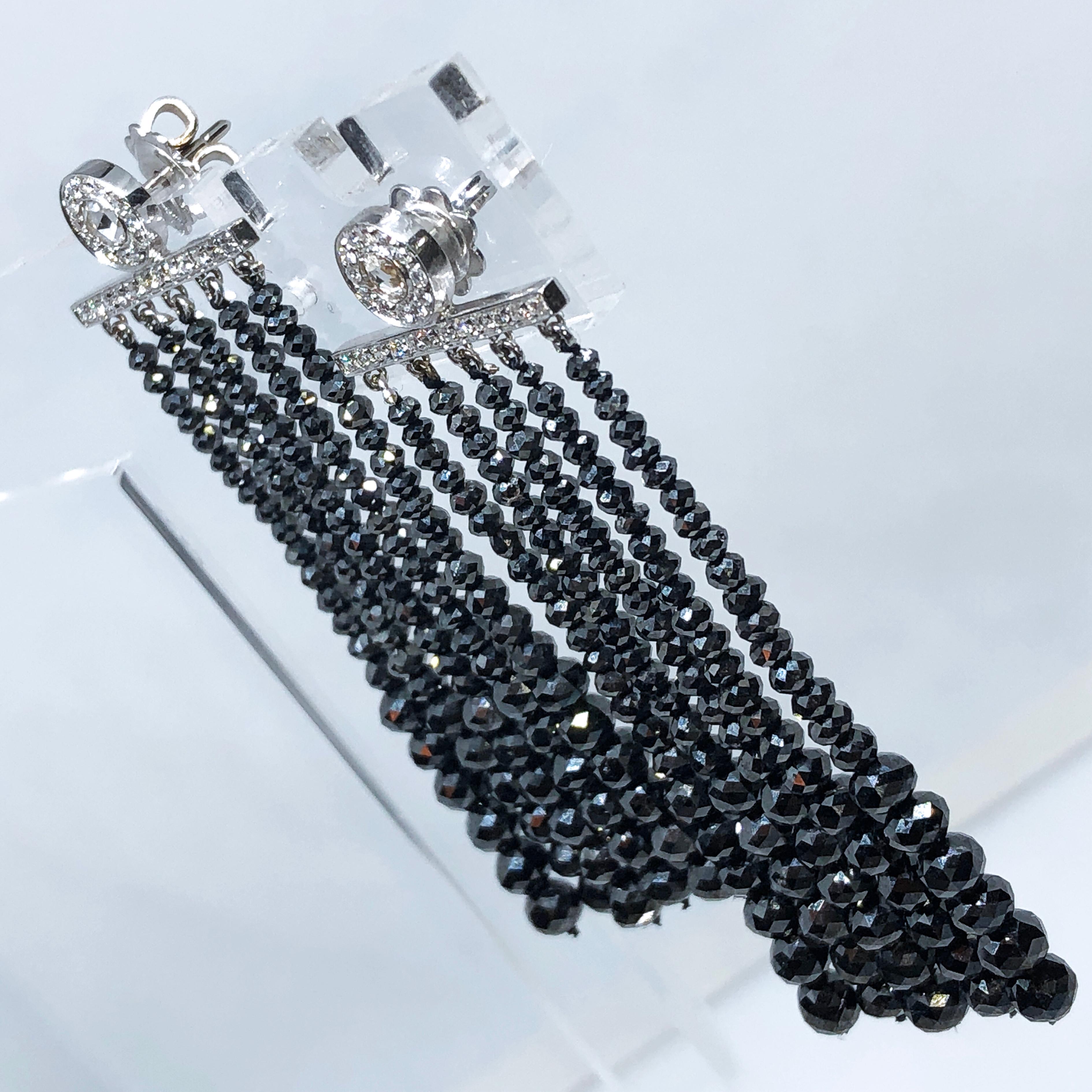 Outstanding, Chic Yet Timeless One-of a kind Dazzling Chandelier Earrings featuring 75.37 Kt Natural Black Diamond 0.59Kt White Diamond(D-E, VVs1) two 0.29 Kt Antique Rose Cut Diamond, total weight 75.25 Kt , 18kt White Gold Setting.
Earrings Total