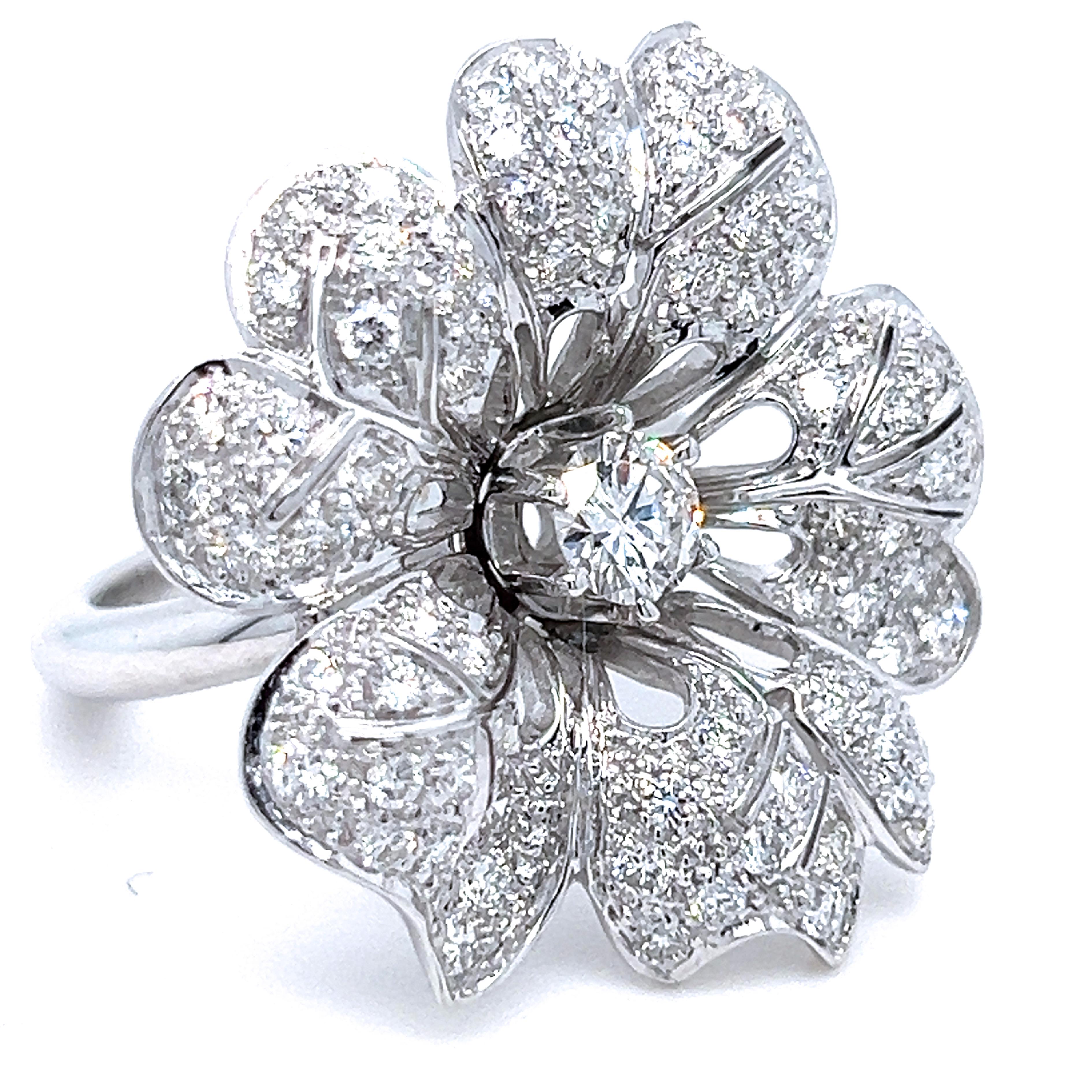 Sumptuos, beautifully handcrafted original 1970 cocktail ring featuring one top quality 0.45kt brilliant cut white diamond surrounded by five round white diamond set leaves, 18 Carat white gold setting.  
US size 6 1/2
French Size 53
We are pleased