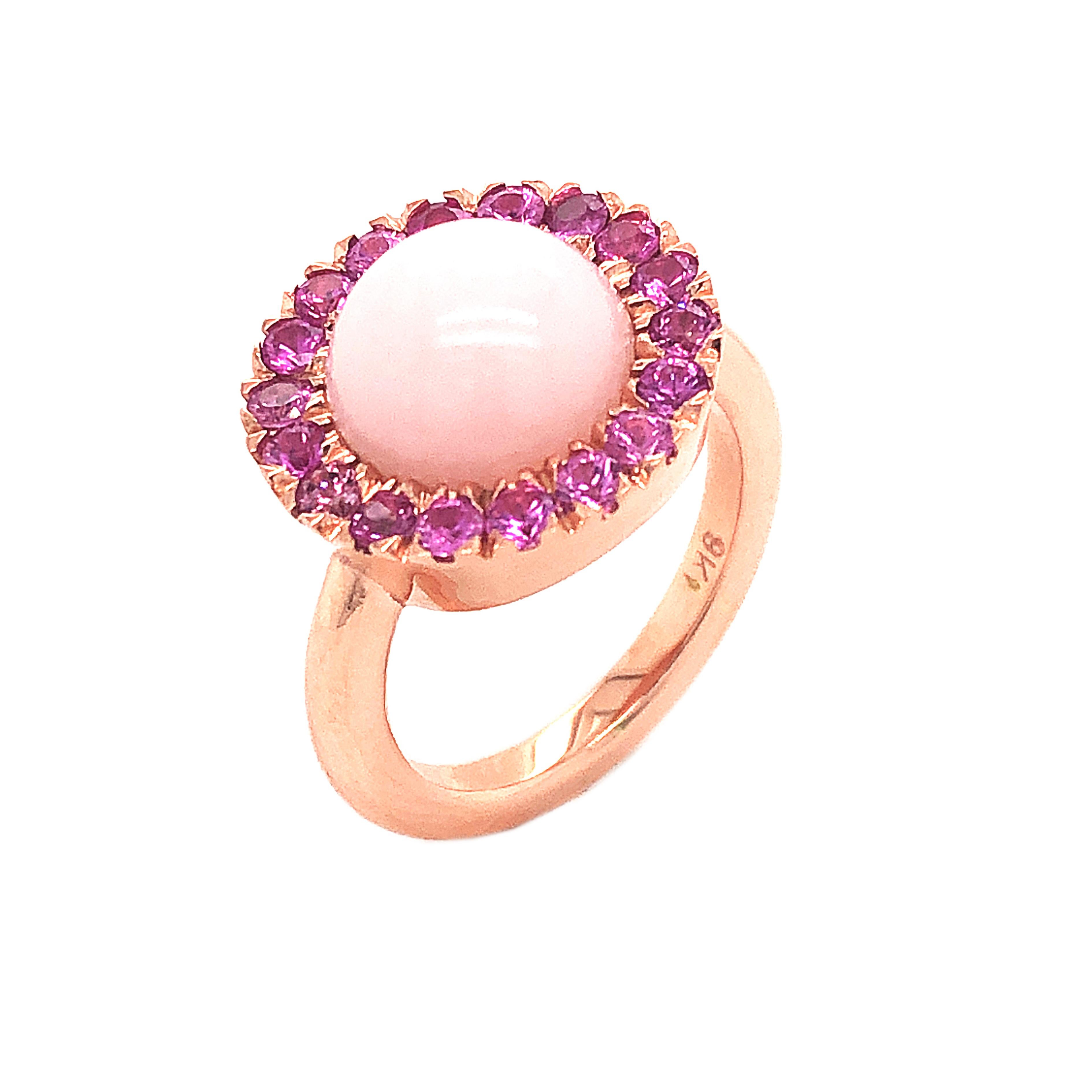 Chic, Unique yet Timeless Contemporary Cocktail Ring featuring a Natural 4.2Kt Rose Opal Round Cabochon surrounded by 1.35Kt Natural Vivid Pink Sapphire in an elegant Rose Gold Setting: a Stunning, Magical Piece.
In our smart Burgundy Leather Box