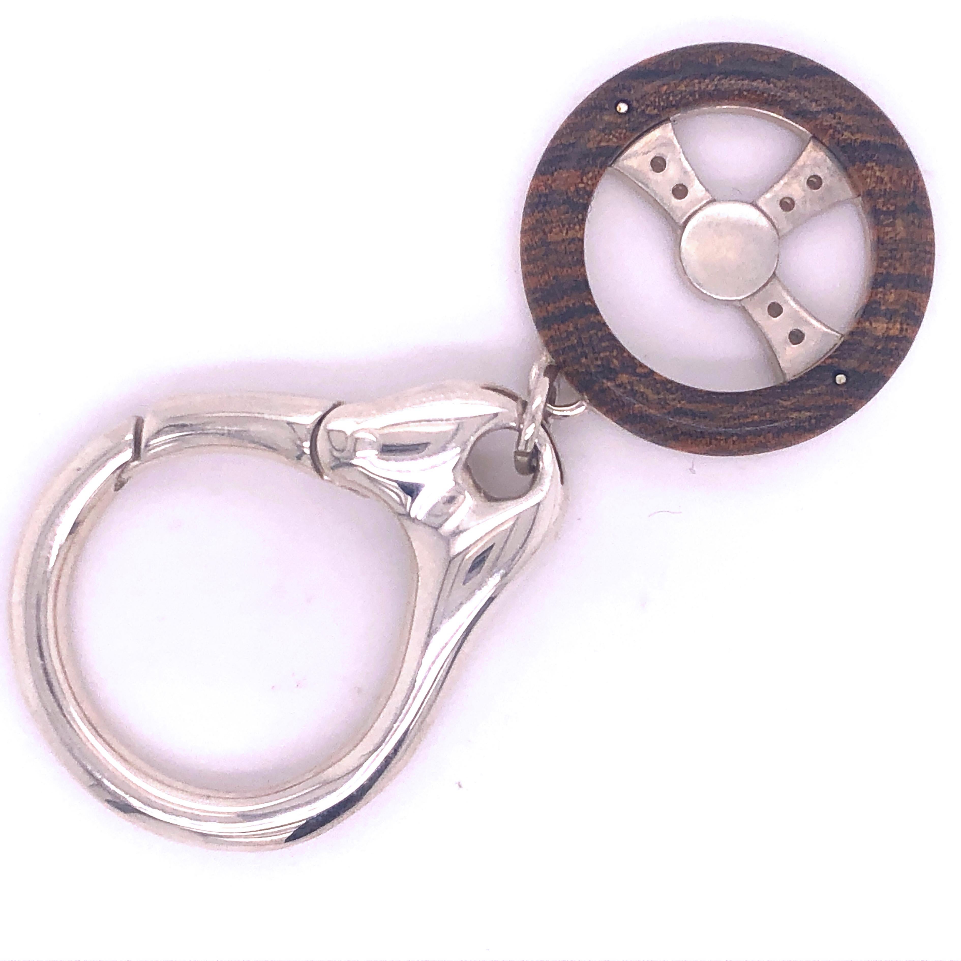 Unique, Chic Yet Timeless Solid Sterling Silver Hand Inlaid Snake Wood Steering Wheel Key Holder.
In our fitted black Box and pouch.
Initials or Key Holder's Name may be complimentary engraved on request on the Steering Wheel Back