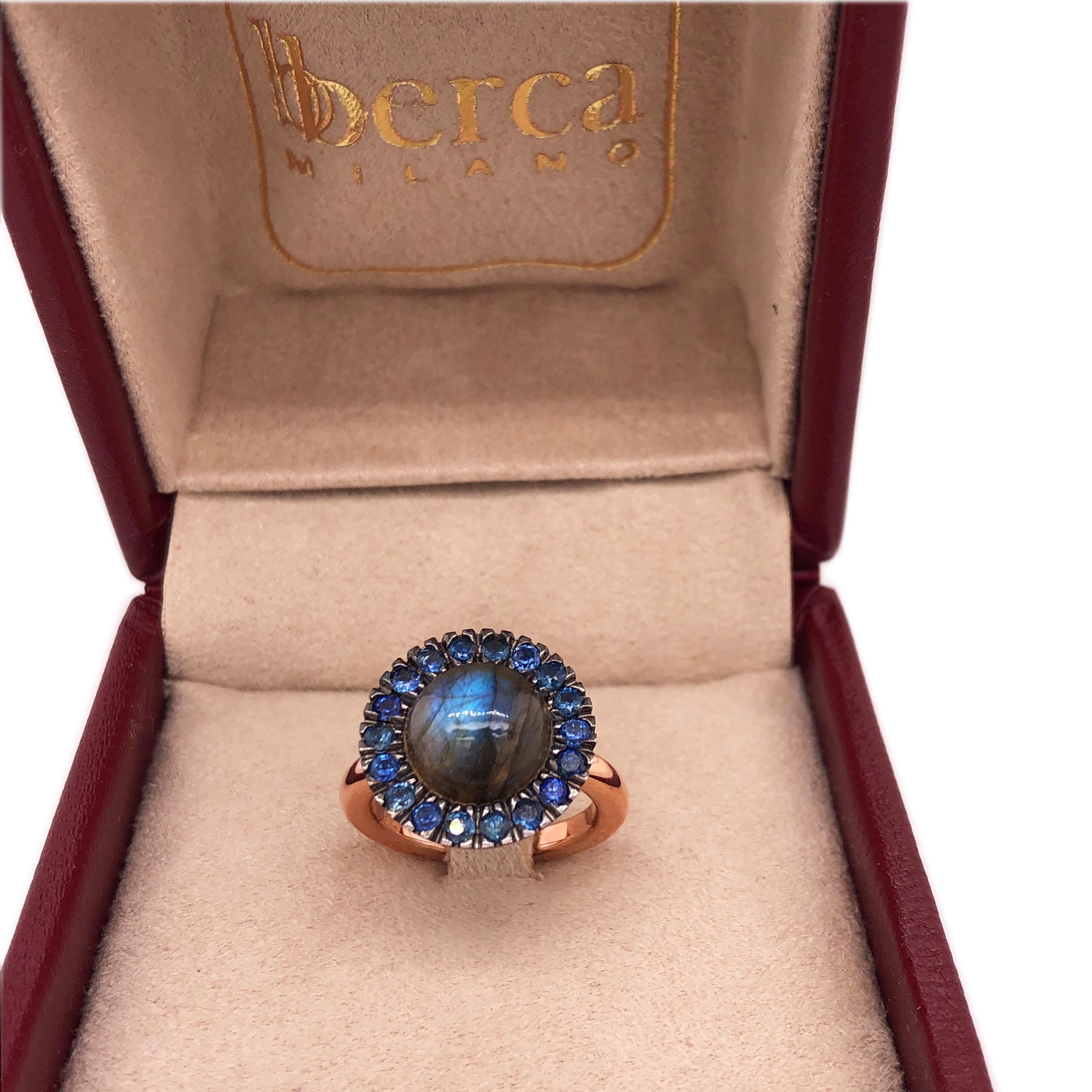 Chic, Unique yet Timeless Contemporary Cocktail Ring featuring a Natural Blue-Teal Color Changing Labradorite Cabochon surrounded by 1.16Kt Natural Blue Sapphire in an elegant Rose and Black Gold Setting: a Stunning, Magical Piece.
In our smart