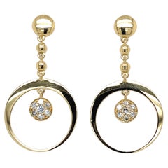 Boucles d'oreilles pendantes en or jaune 18k et diamants blancs de BERCA