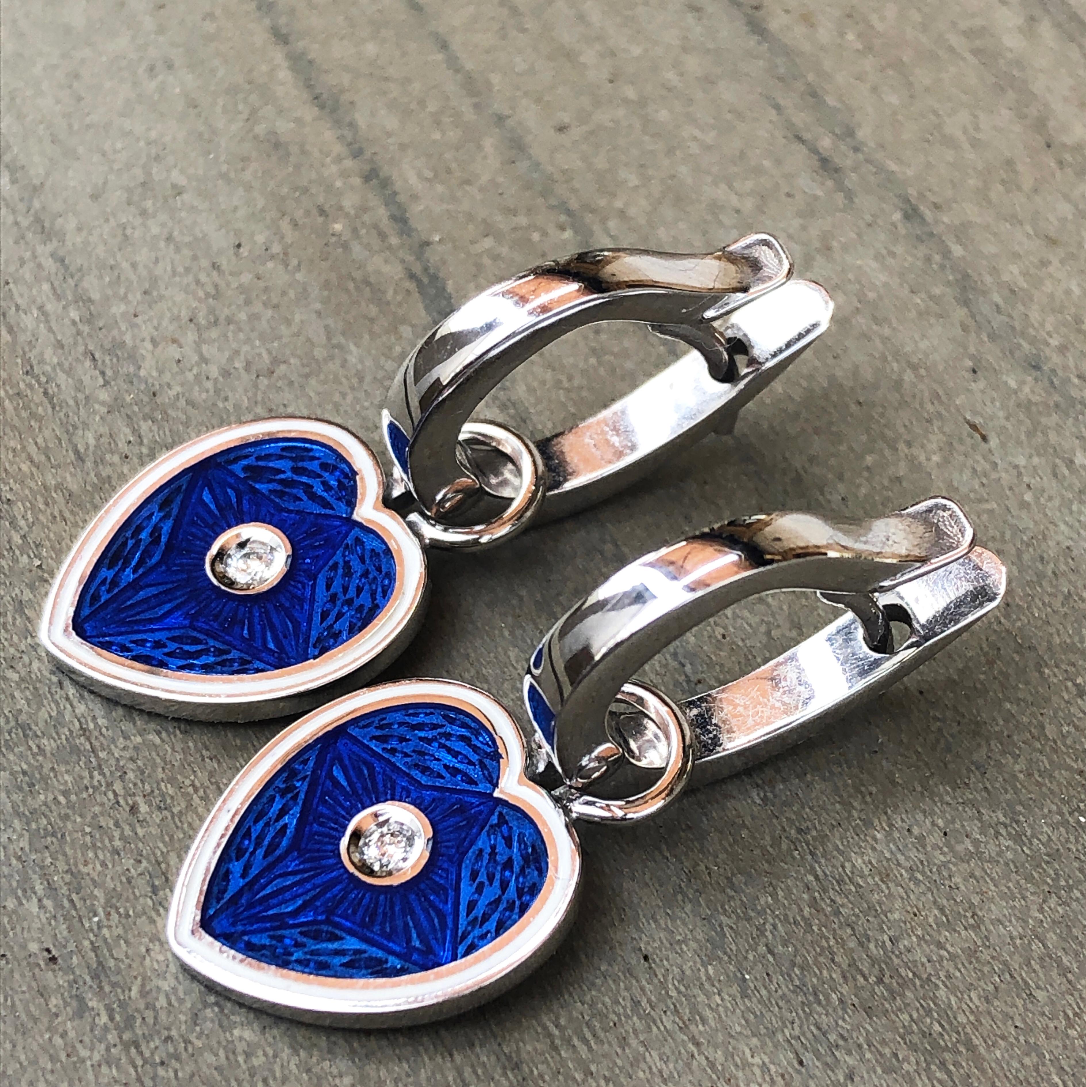 Chic yet timeless 0.07 Carat White Diamond in a White Edged Royal Blue Heart Shaped Removable Pendant in a White Gold Setting.
This brilliant setting allows to wear these lovely earrings both ways.

In our smart Burgundy Lether Box.
A detailed