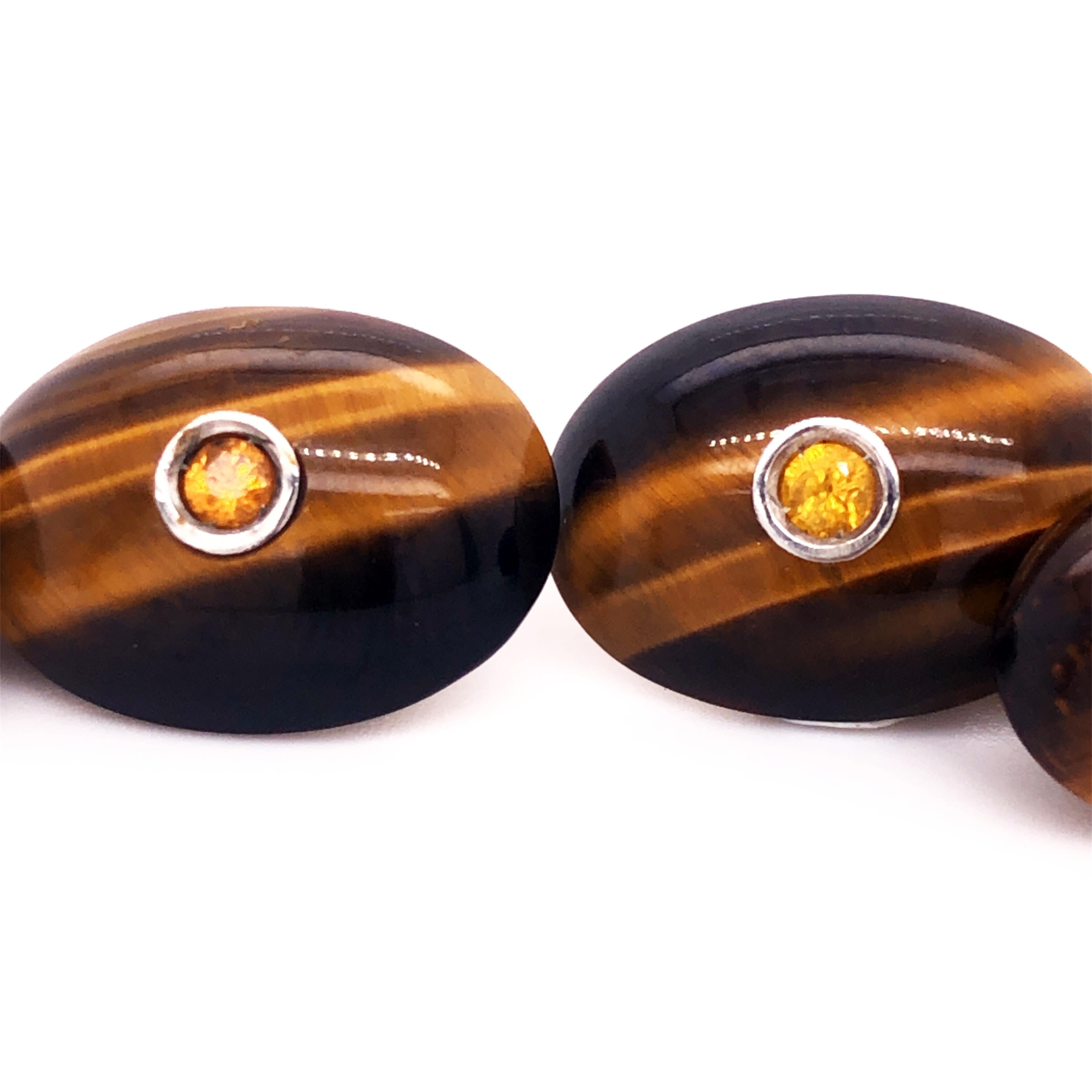 Absolutely Chic, Classy yet Timeless Oval Shaped Hand Inlaid Natural Tiger's Eye Cufflinks featuring four natural 0.48 Carat Brilliant Cut Yellow Sapphire in a White Gold setting.
All our Cufflinks are new, never been previously owned or worn, gift