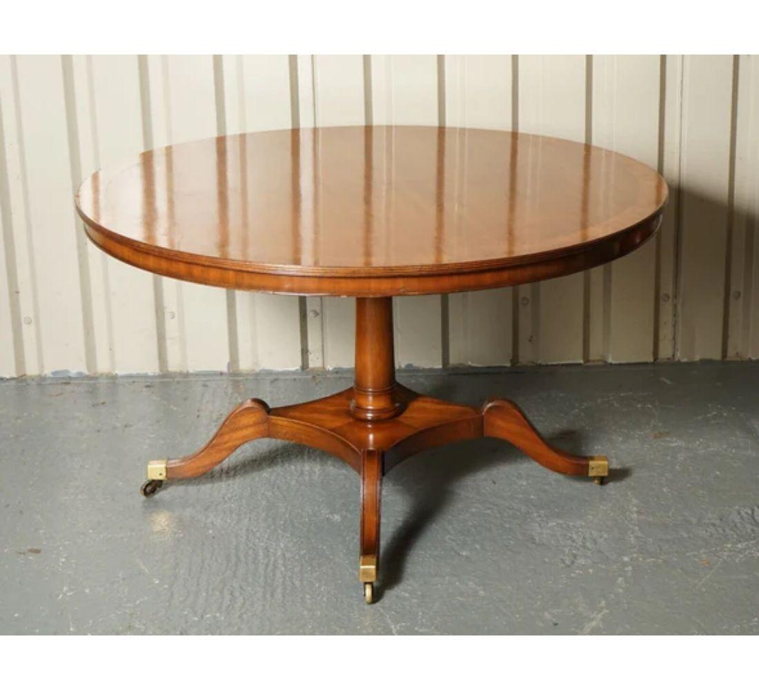 We are delighted to offer for sale this Beautiful Beresford & Hicks Dining Table Made From Walnut And Burr Walnut On The Top.

The table is raised on solid brass feet plates with large castors. The tabletop can be screwed off if needed for more