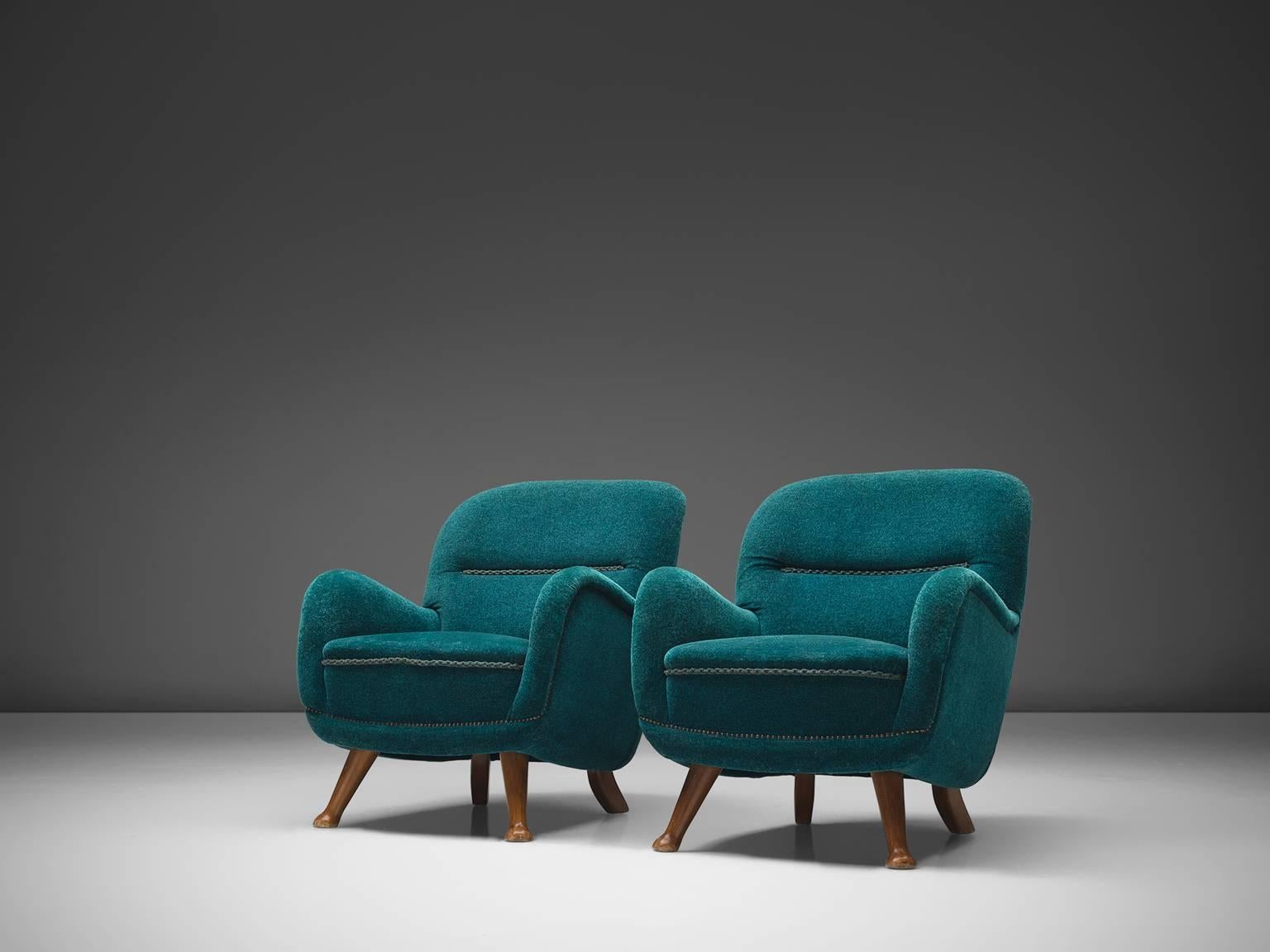 Berga Møbler, pair of armchairs, blue fabric, beech, Sweden, 1940s.

This bold and curvy set of armchairs are very comfortable and strong singular items. The whole shell is slightly tilted backwards. The shell rests on four small beech legs that