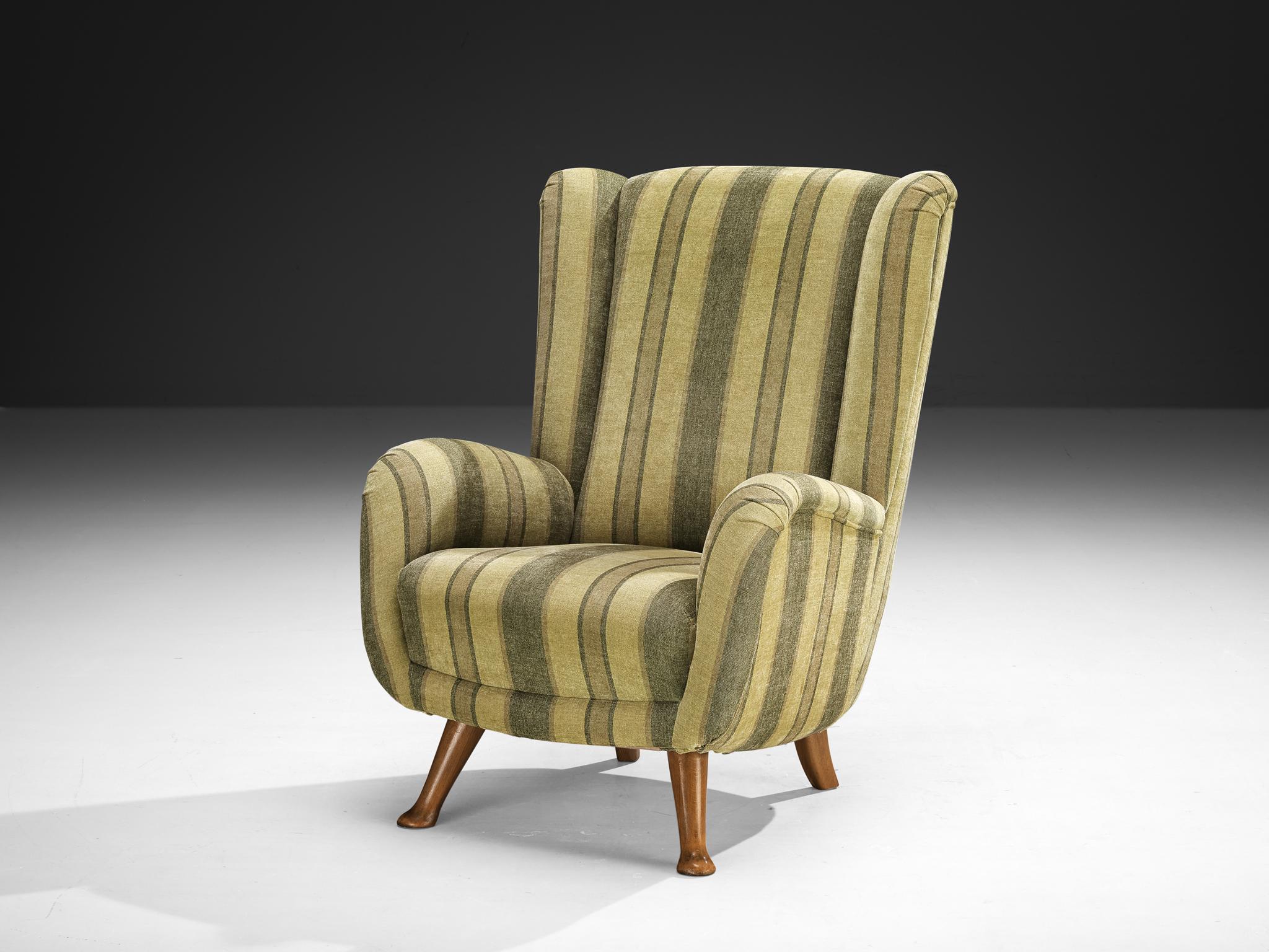 Berga Mobler, highback armchair, fabric, beech, Denmark, 1940s

This bold and curvy armchair is based on a solid construction with a tender touch due to the soft texture of a green striped fabric. The whole shell is slightly tilted backwards. The