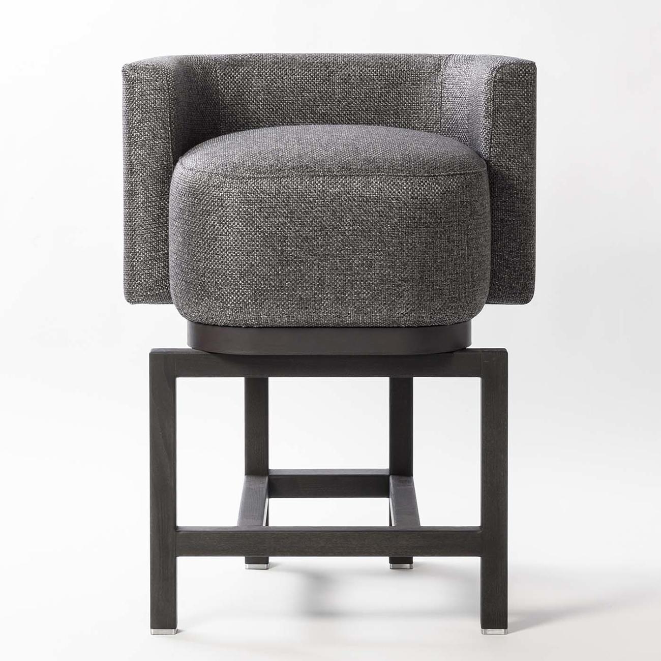 Bar stool Bergam with solid walnut base
in blackened finish. Upholstered and covered
seat with cashmere and wool fabric.