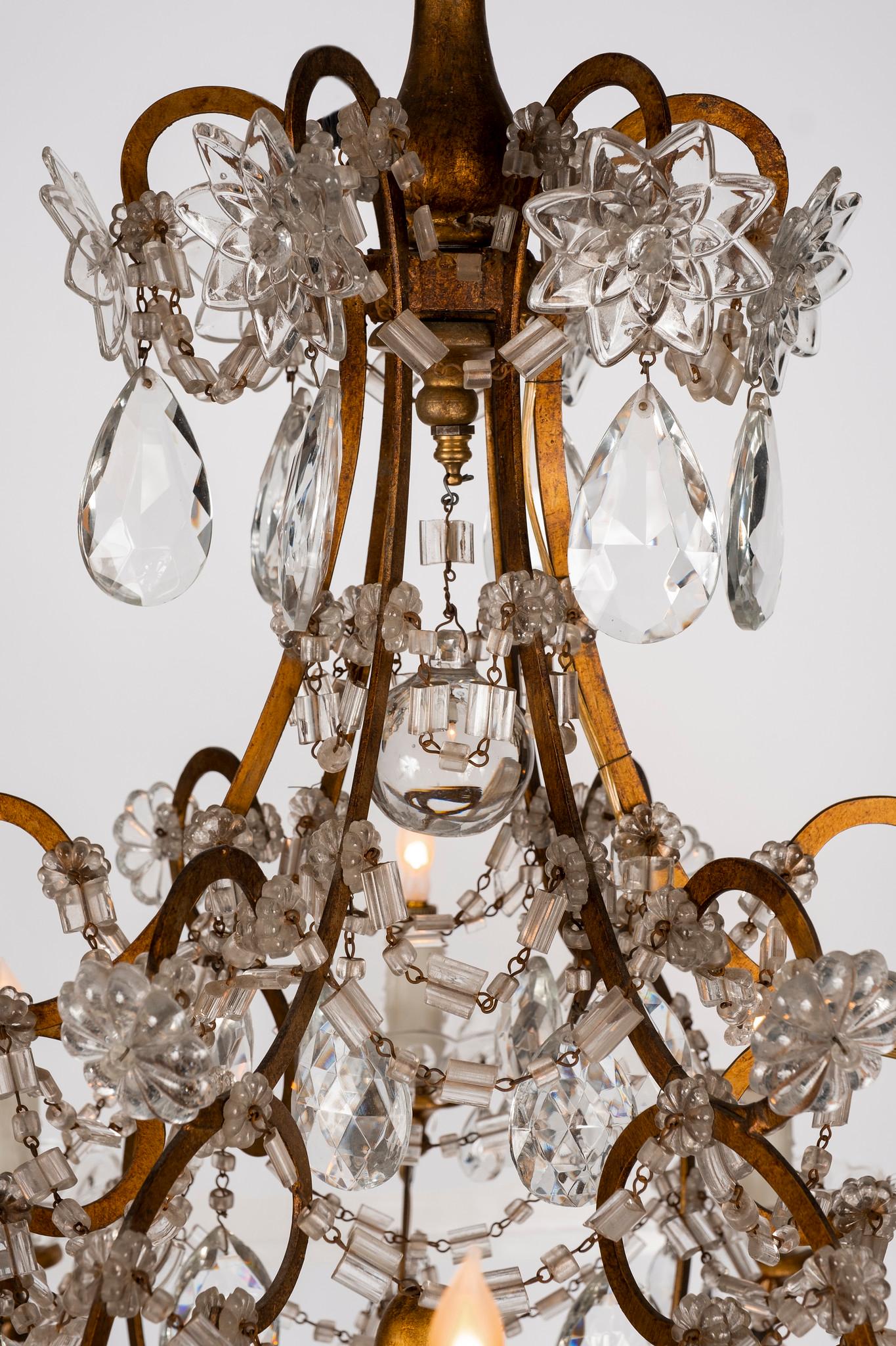 A vintage twelve-arm gilt carved wood and crystal chandelier made with antique and new parts from Begamo, Italy. Newly electrified.
   