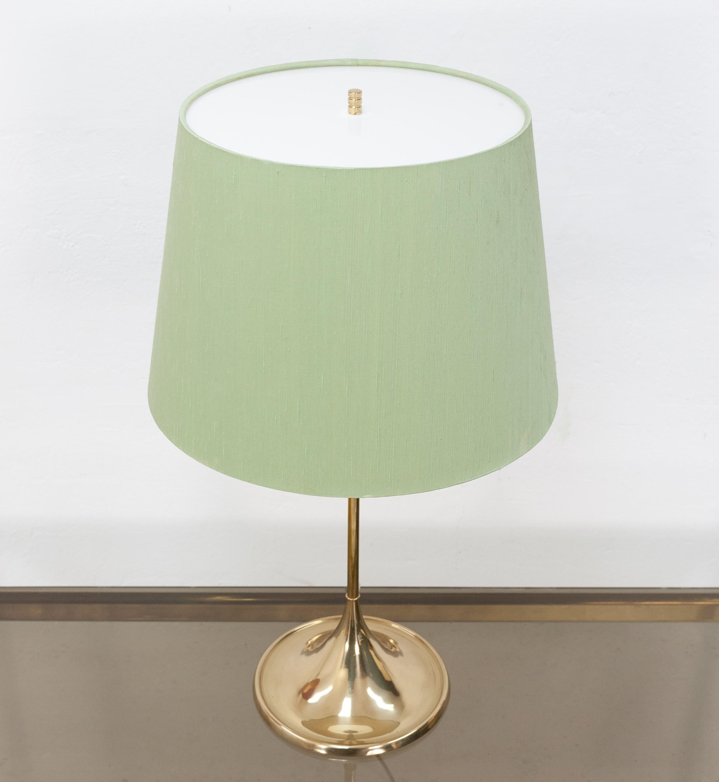 Beautiful table version of the iconic Bergbom design. Model B-024 cast iron base finished in brass with an opaque white Perspex top on the light original green linen lampshade. Very nice condition.