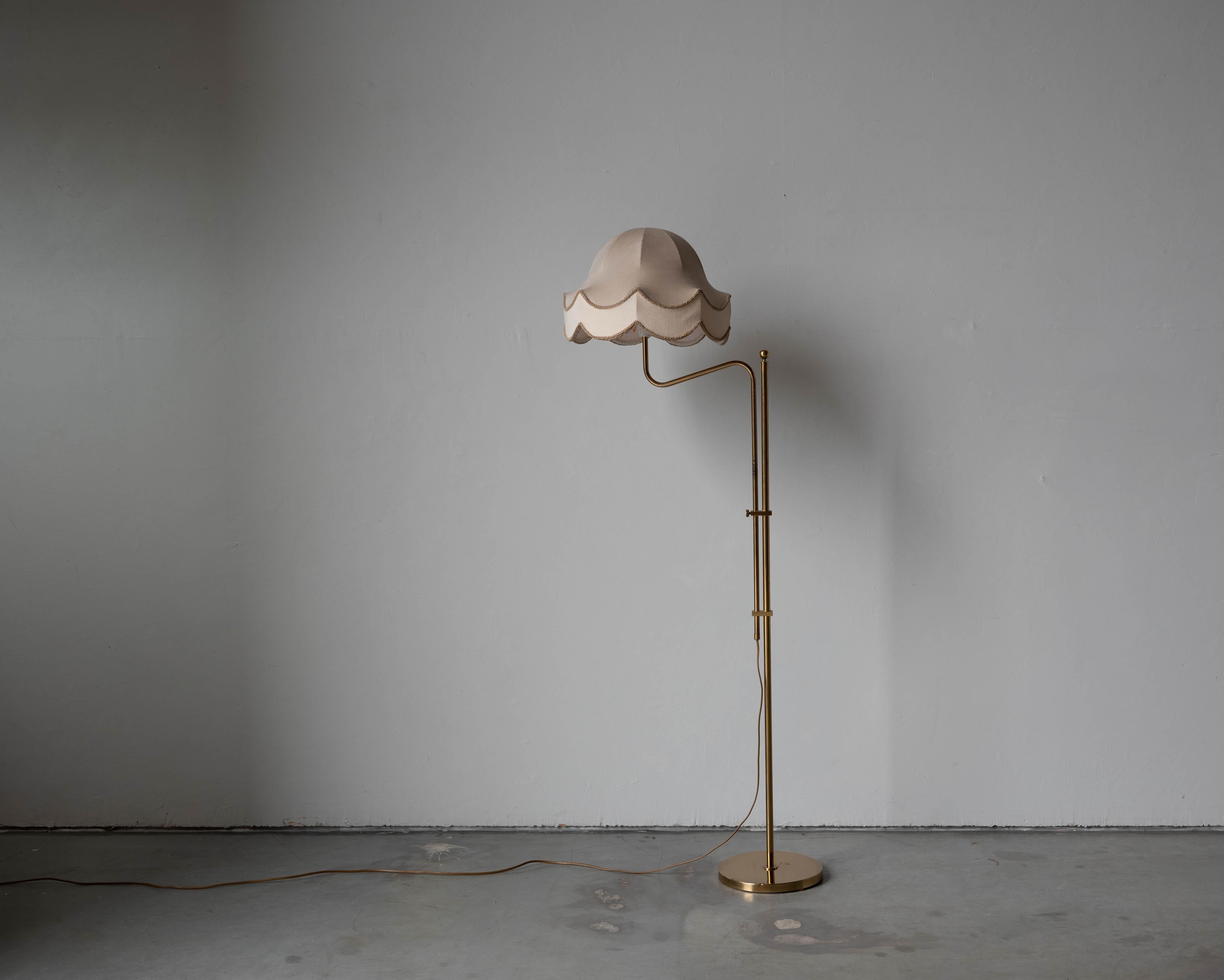 A brass and metal floor lamp designed and produced by Bergboms, Sweden, c. 1960s.

Sold with Lampshade. 
Dimensions stated refer to the floor lamp with the shade. 

