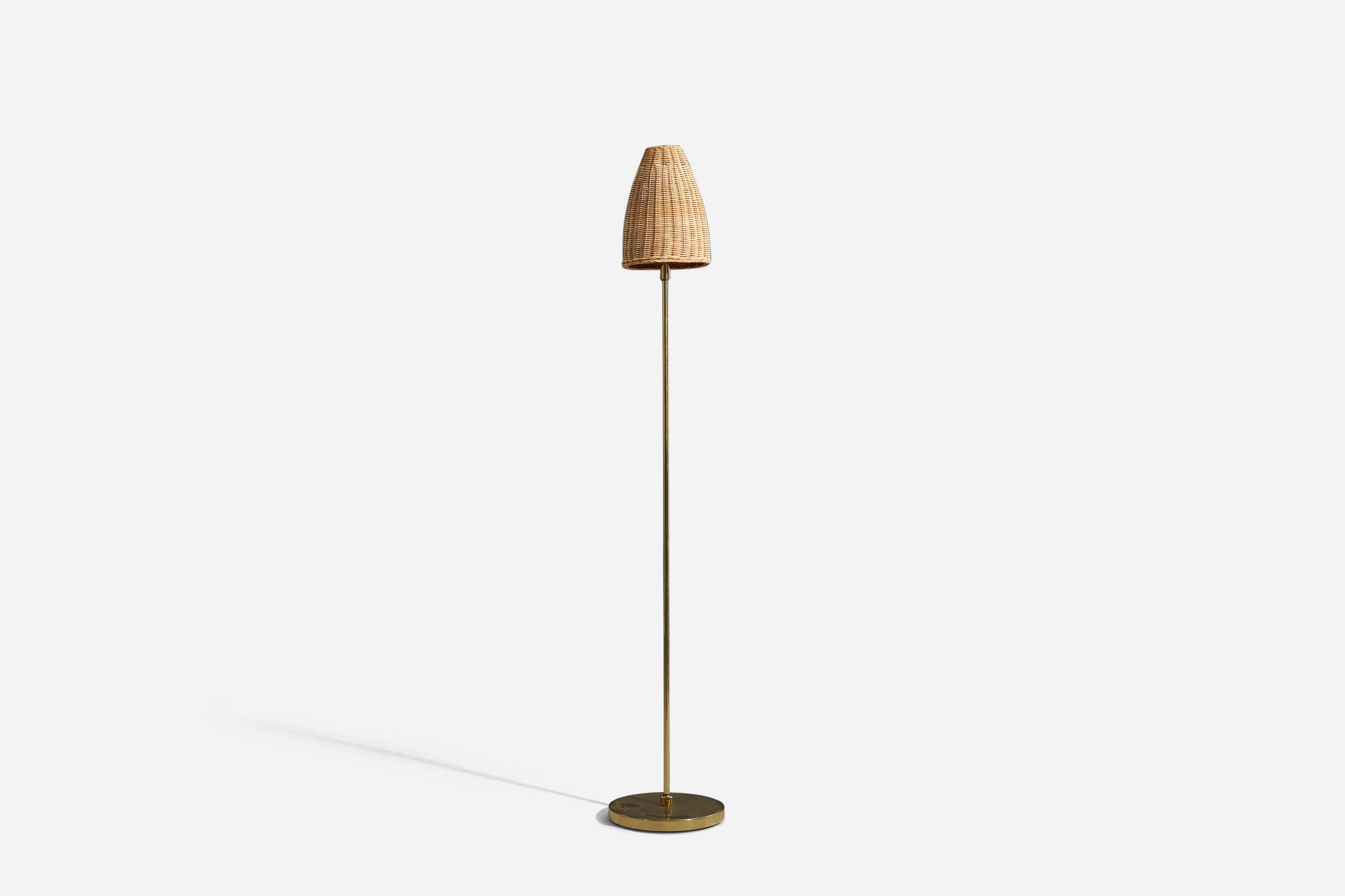 A brass and rattan, adjustable floor lamp designed and produced by Bergboms, Sweden, c. 1970s.

Variable dimensions, measured as illustrated in the first image.

Sold with Lampshade. 
Dimensions stated refer to the floor lamp with the shade.