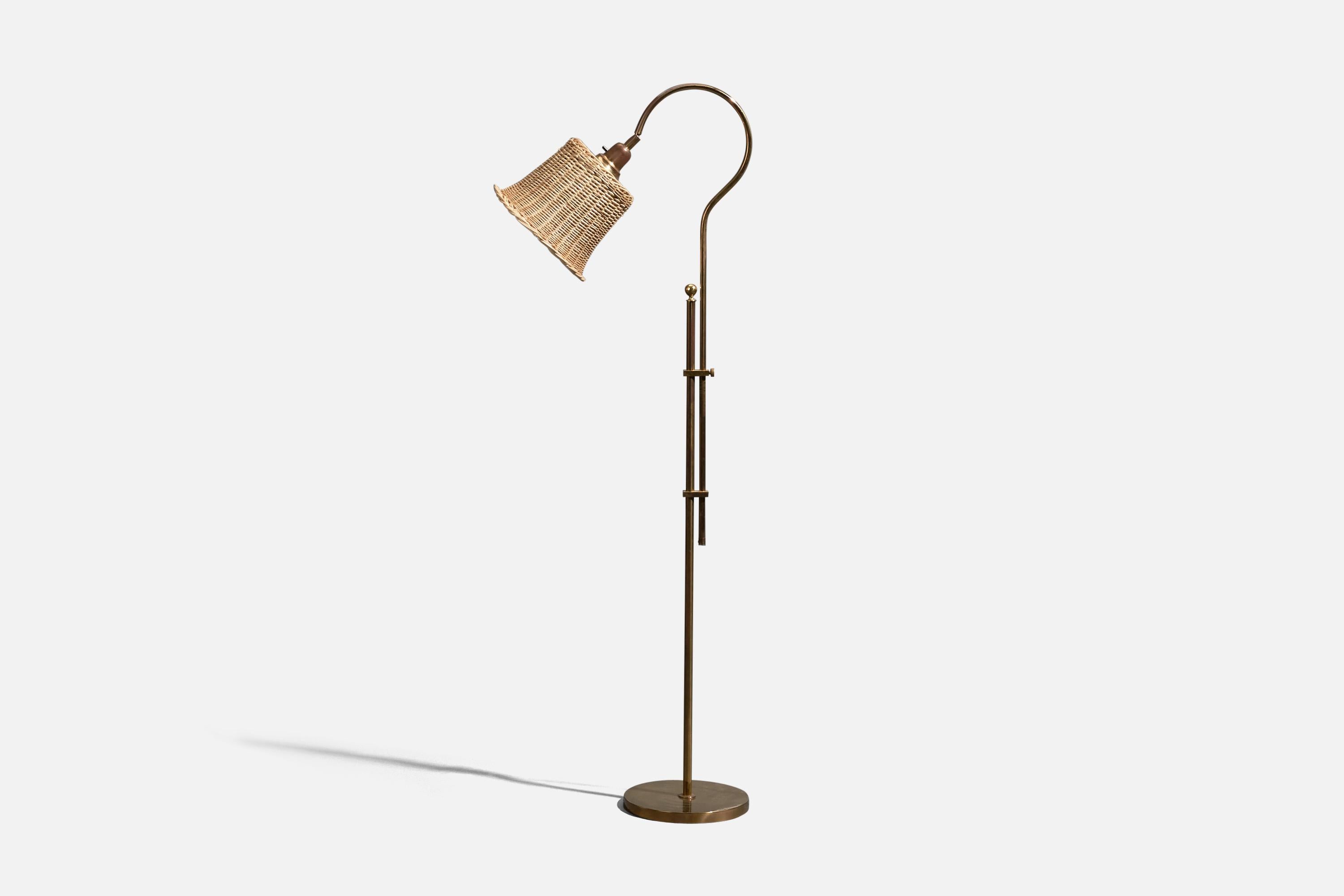 An adjustable, brass and rattan floor lamp designed and produced in Sweden, 1970s.

Dimensions variable, measured as illustrated in first image.

Sold with Lampshade. Dimensions stated are of Floor Lamp with Lampshade. 

Socket takes standard