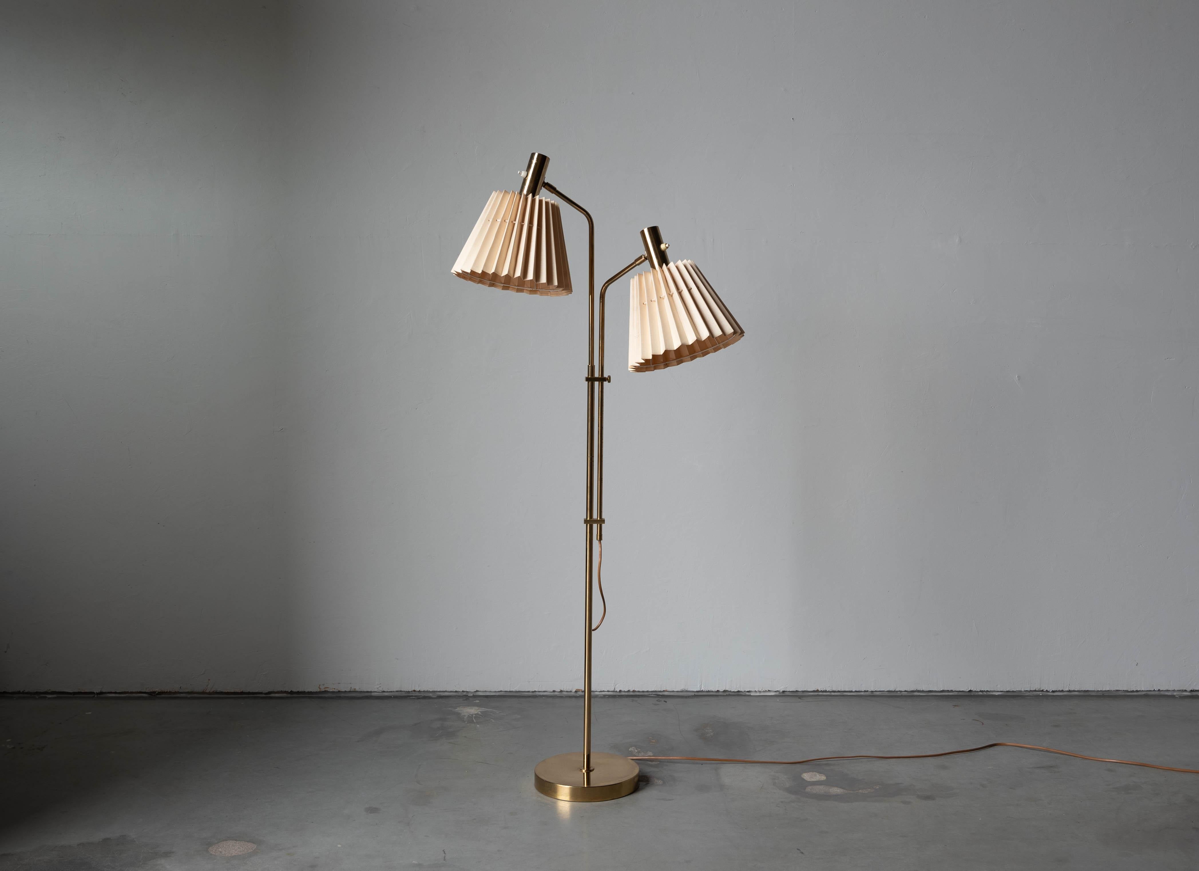 A brass and metal floor lamp designed and produced by Bergboms, Sweden, c. 1960s.

Sold with Lampshade. 
Dimensions stated refer to the floor lamp with the shade. 

