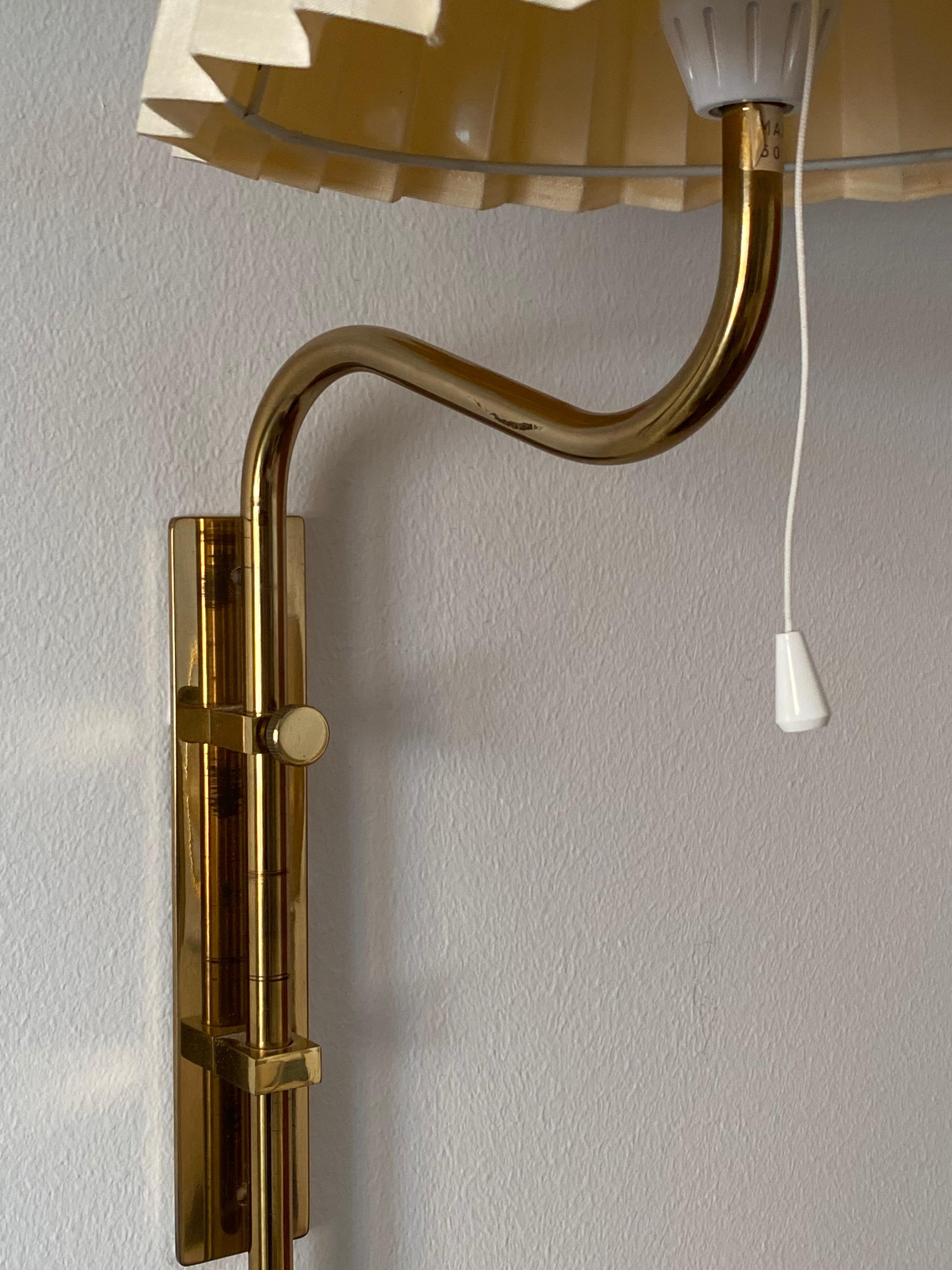 A pair of adjustable wall lights / wall sconces. Designed and produced by Bergboms, Sweden, 1960s. Labeled.

Features its original lampshades.

Other designers of the period include Paavo Tynell, Hans Bergström, Josef Frank, and Kaare Klint.