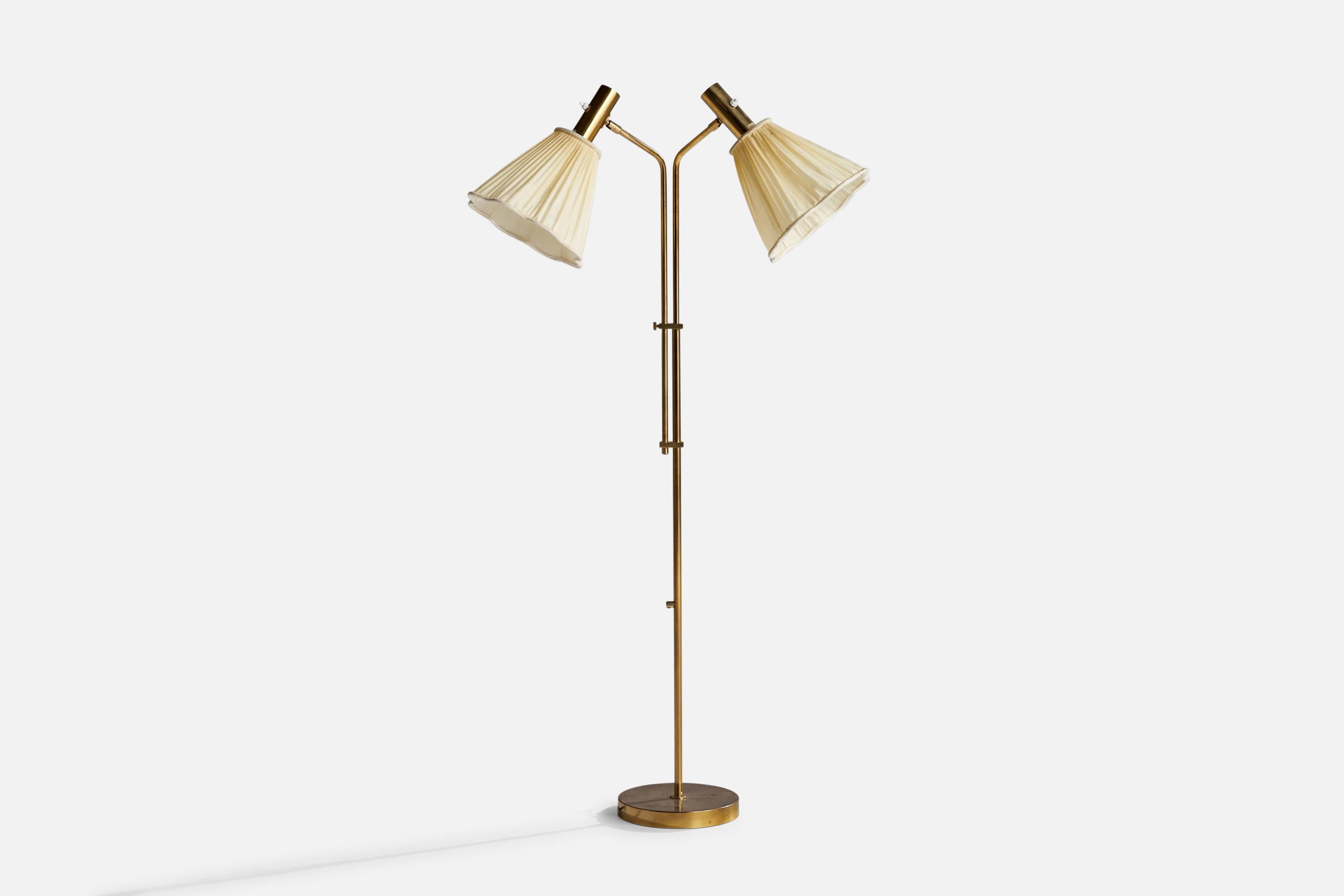 An adjustable two-armed brass and beige fabric floor lamp designed and produced by Bergboms, Sweden, 1960s.

Dimensions variable.

Overall Dimensions (inches): 54.5”  H x 24” W x 20” D
Stated dimensions include shade.
Bulb Specifications: E-26