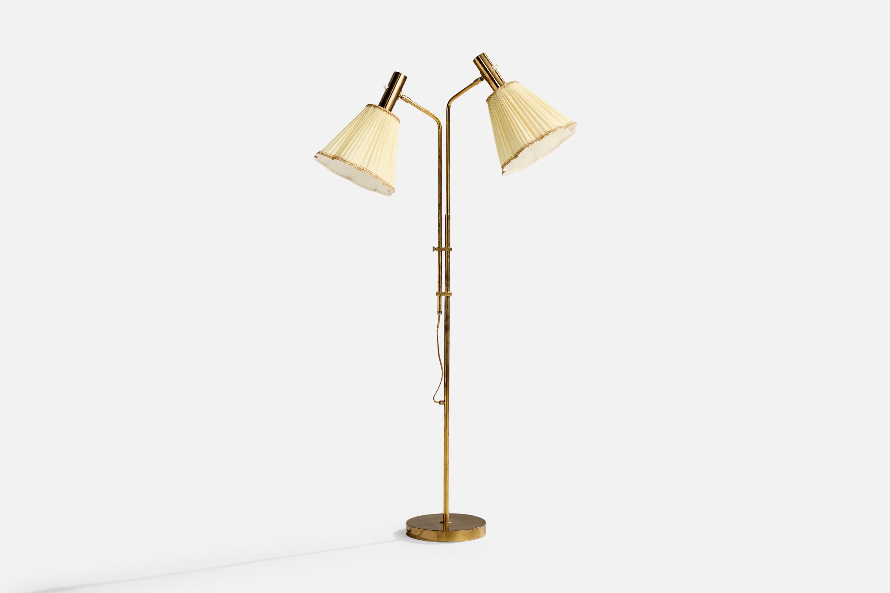 An adjustable brass and beige fabric floor lamp produced by Bergboms, Sweden, c. 1970s.

Dimensions of Lamp with Shade (inches): 54.75