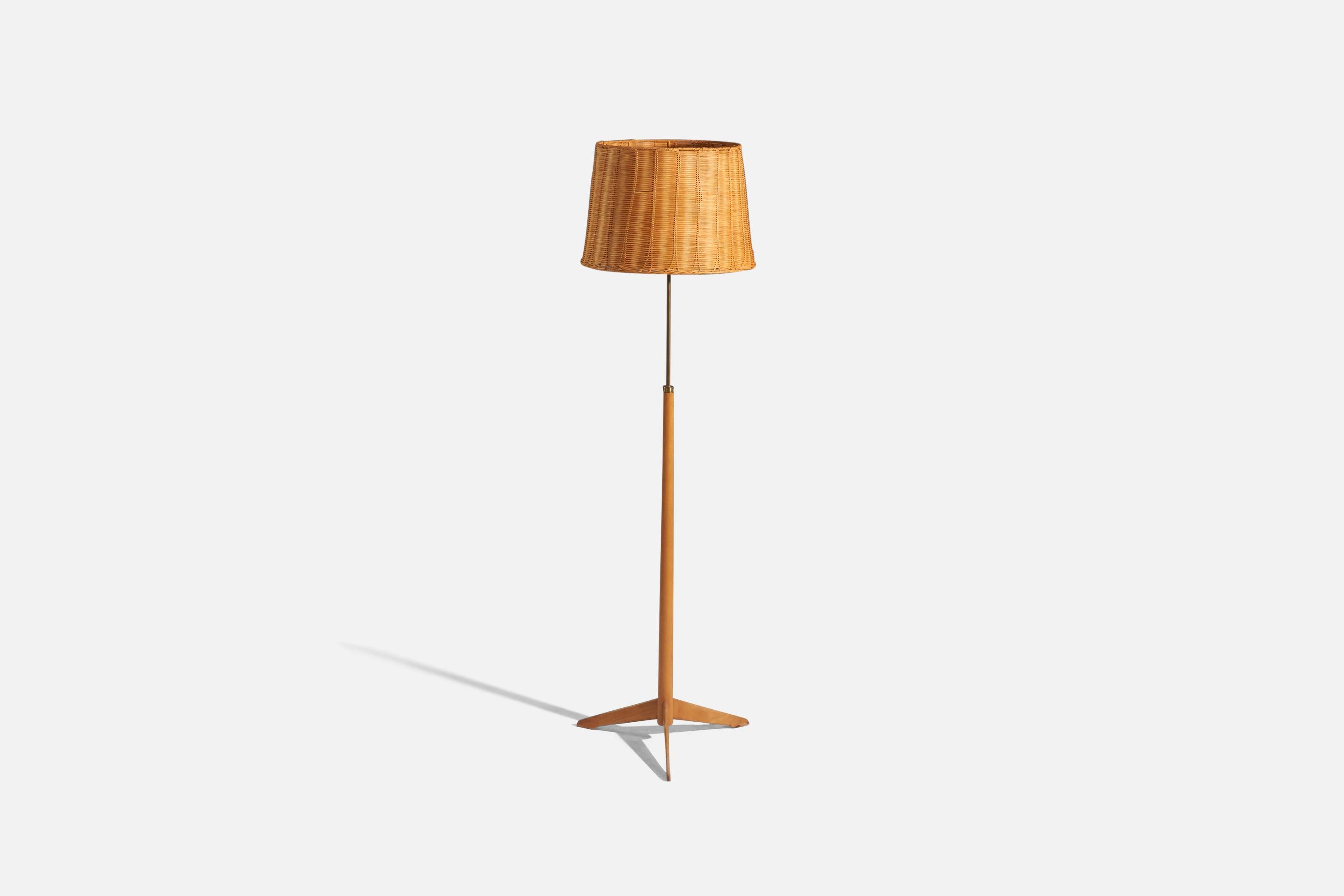 An adjustable, brass, stained oak and rattan floor lamp designed and produced by Bergboms, Sweden, c. 1970s. 

Variable dimensions, measured as illustrated in the first image.
Sold with Lampshade(s). 
Stated dimensions refer to the Floor Lamp with