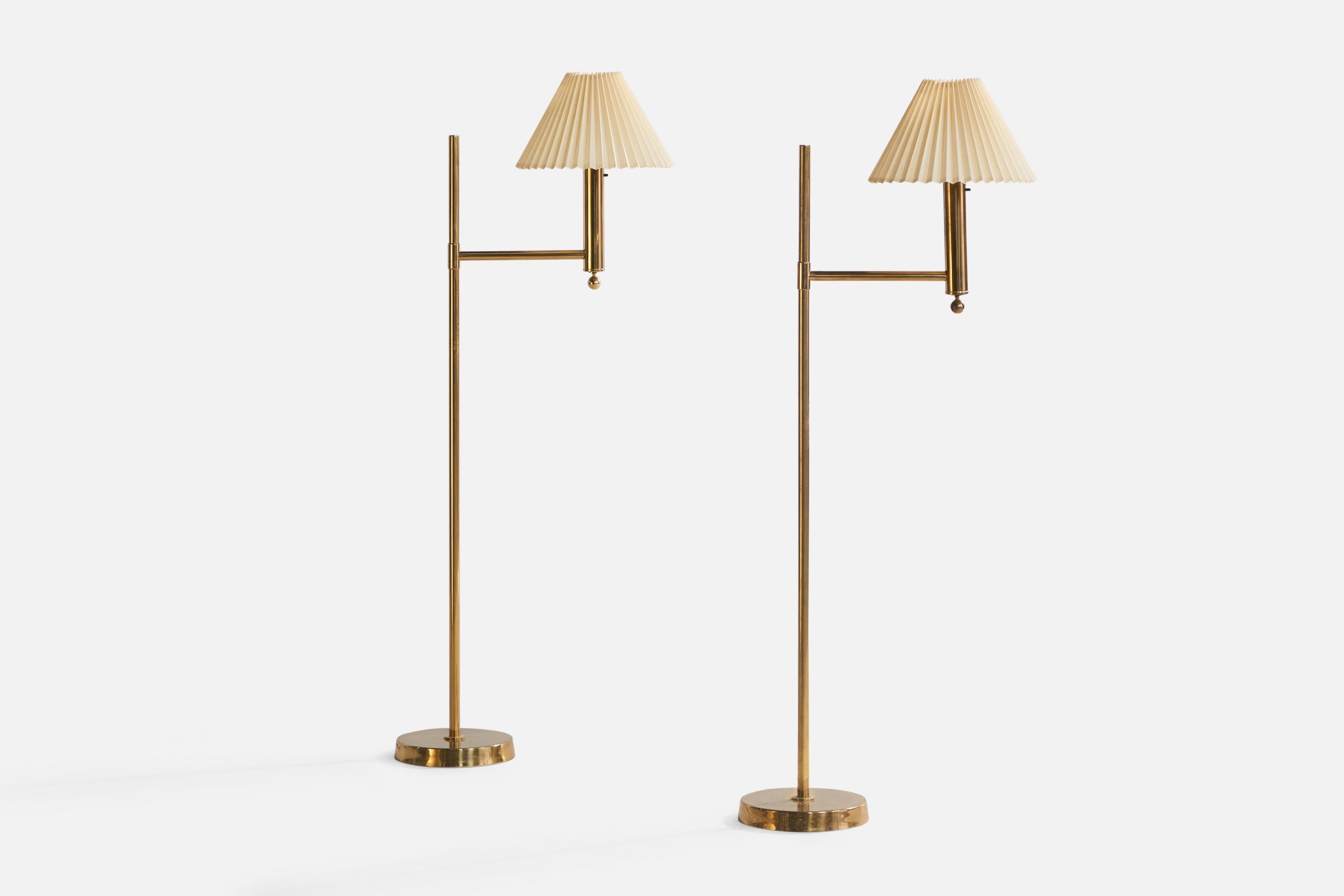 A pair of brass and beige fabric floor lamps designed and produced by Bergboms, Sweden, 1960s.

Overall Dimensions (inches): 51.5” H x 12” W x 21.25” Depth. Stated dimensions include shade.
Bulb Specifications: E-26 Bulbs
Number of Sockets: 2
All