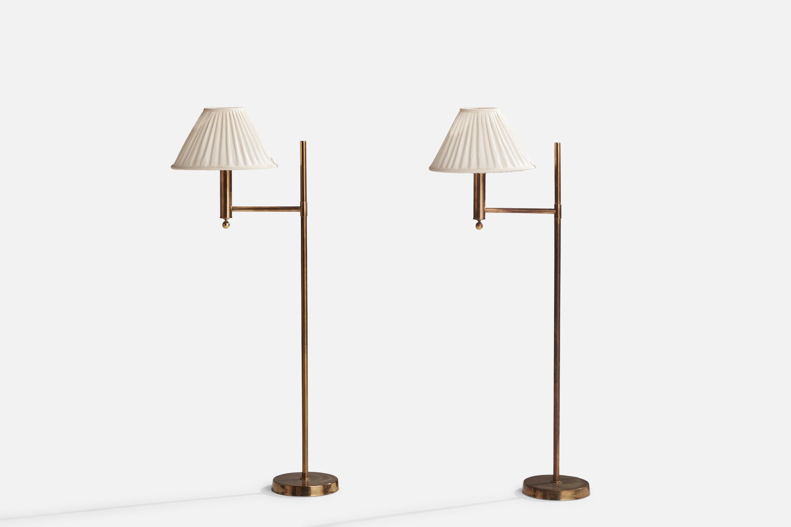 A pair of brass and off-white fabric floor lamps designed and produced in Sweden, 1970s.

Overall Dimensions (inches): 52” H x 14.5” W x 23.5” D
Stated dimensions include shade.
Bulb Specifications: E-26 Bulb
Number of Sockets: 2
All lighting will