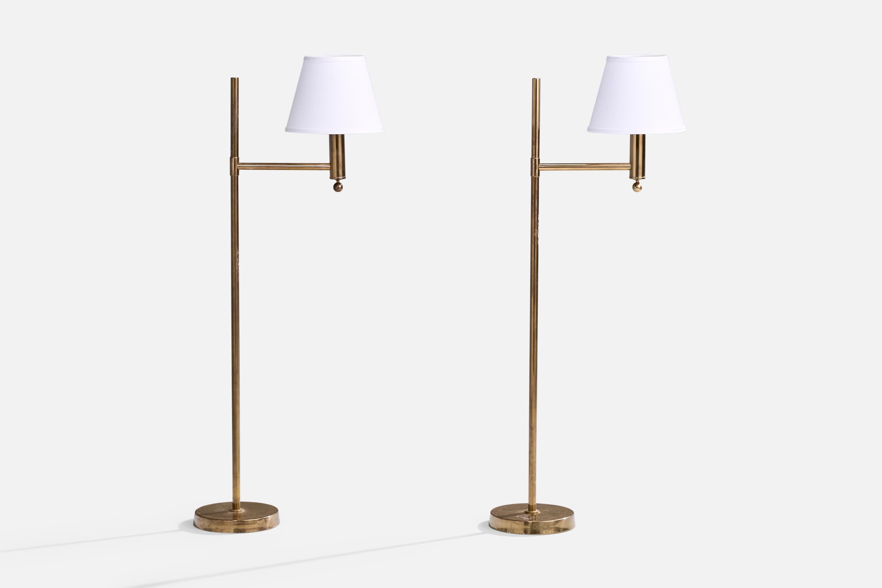 A pair of brass and white fabric floor lamps designed and produced by Bergboms, Sweden, c. 1970s.

The brass presents with moderate discoloration throughout the lamps. Brand new lampshades.

Dimensions of Lamp with Shade (inches): 49.4” H x 10.4” W