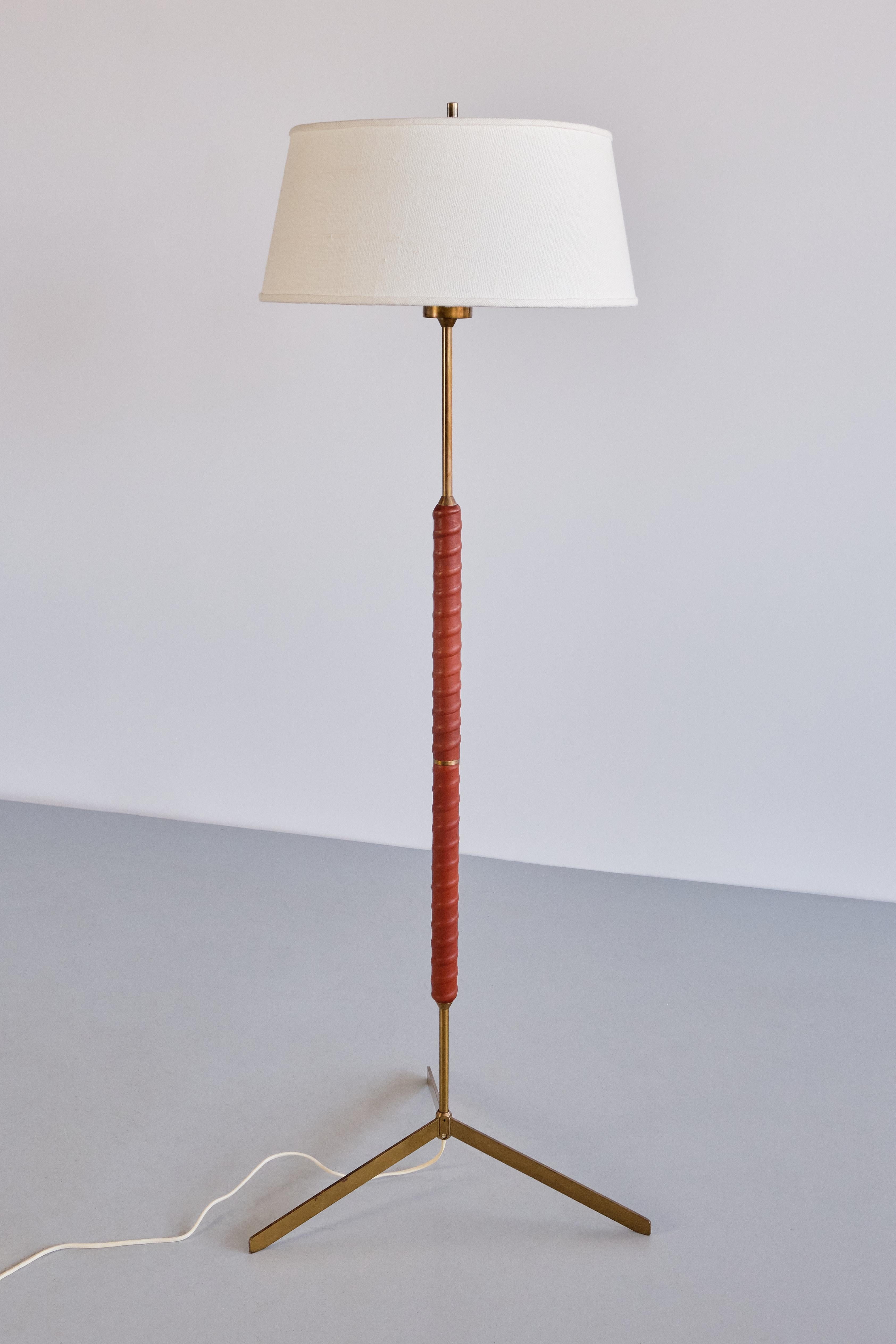 This floor lamp was produced by Bergboms in Sweden in the late 1940s. The design is model G-31, as marked on the underside of the base.

It features a striking three-legged base that leads into a central tube, all crafted from matte brass with a