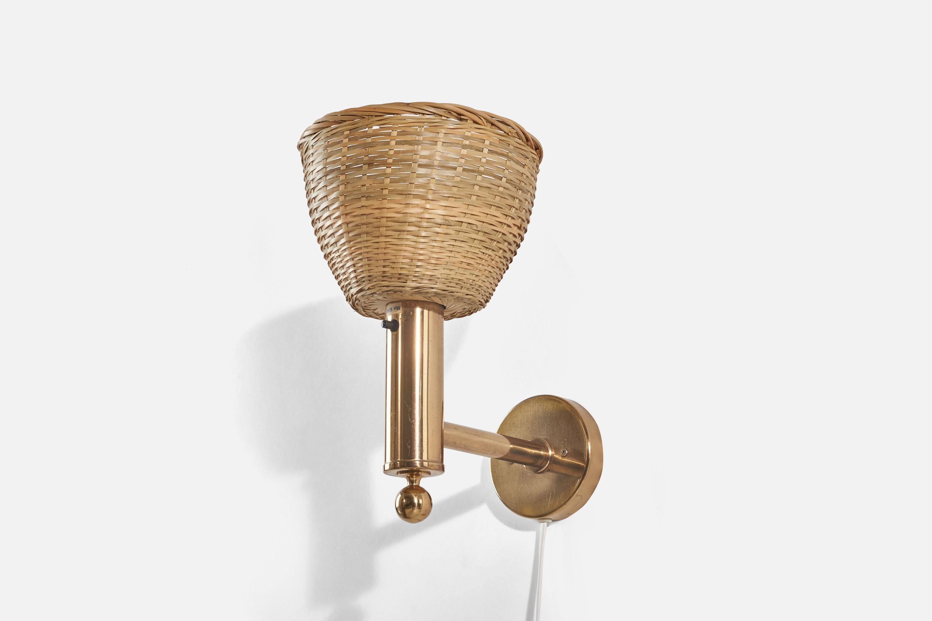 A brass and rattan sconce / wall light designed and produced by Bergboms, Sweden, 1970s. 

Sold with Lampshade(s). Dimensions stated are of Sconce with Shade(s).

Dimensions of Back Plate (inches) : 3.82 x 3.82 x 0.78 (Height x Width x