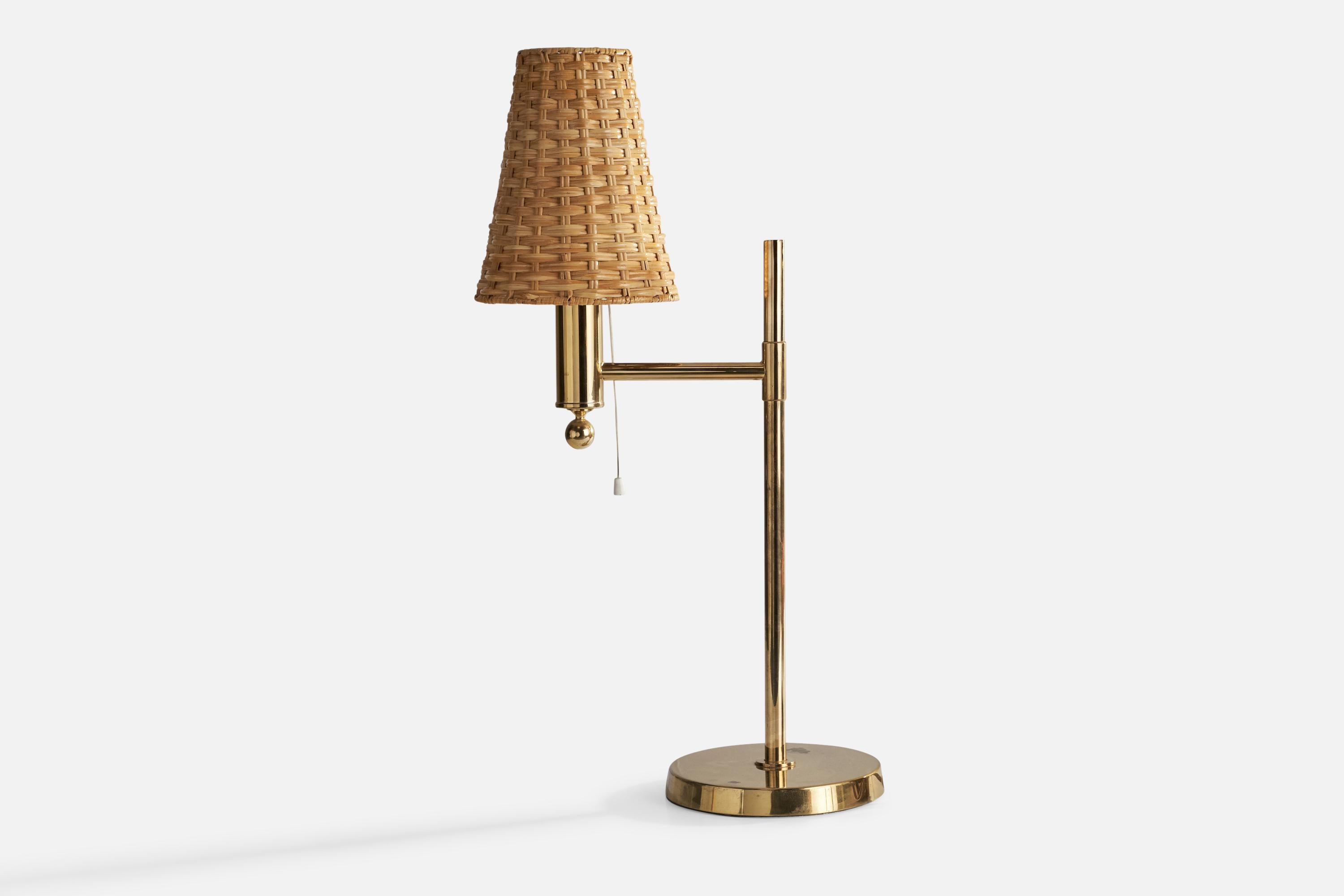 A brass and rattan table lamp designed and produced by Bergboms, Sweden, c. 1970s.

Overall Dimensions (inches): 19.25”  H x 7.25” W x 8” D
Stated dimensions include shade.
Bulb Specifications: E-26 Bulb
Number of Sockets: 1
All lighting will be