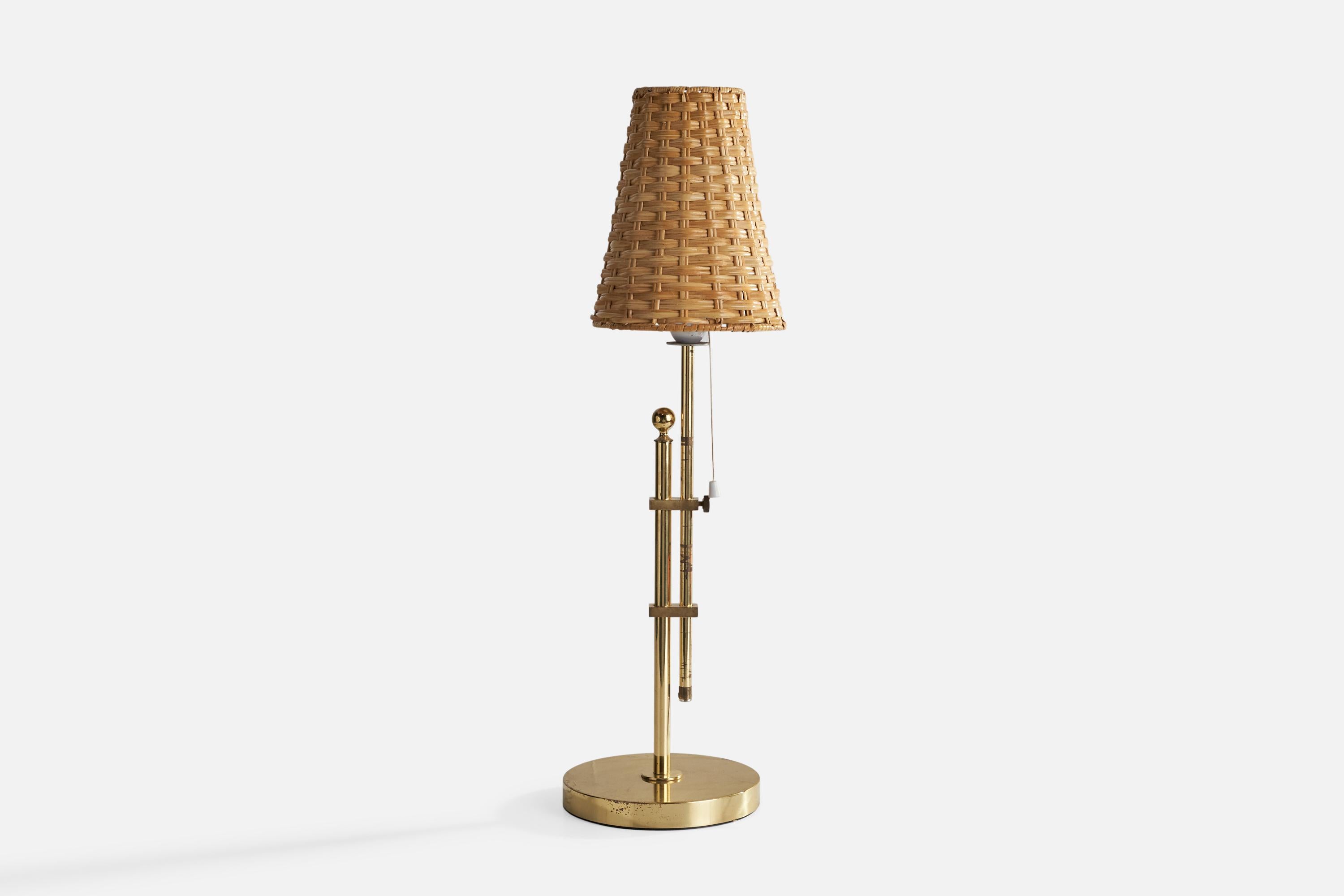 A brass and rattan table lamp designed and produced Bergboms, Sweden, c. 1980s.

Overall Dimensions (inches): 23.23 H x 7.49”  D
Stated dimensions include shade.
Bulb Specifications: E-26 Bulb
Number of Sockets: 1
All lighting will be converted for