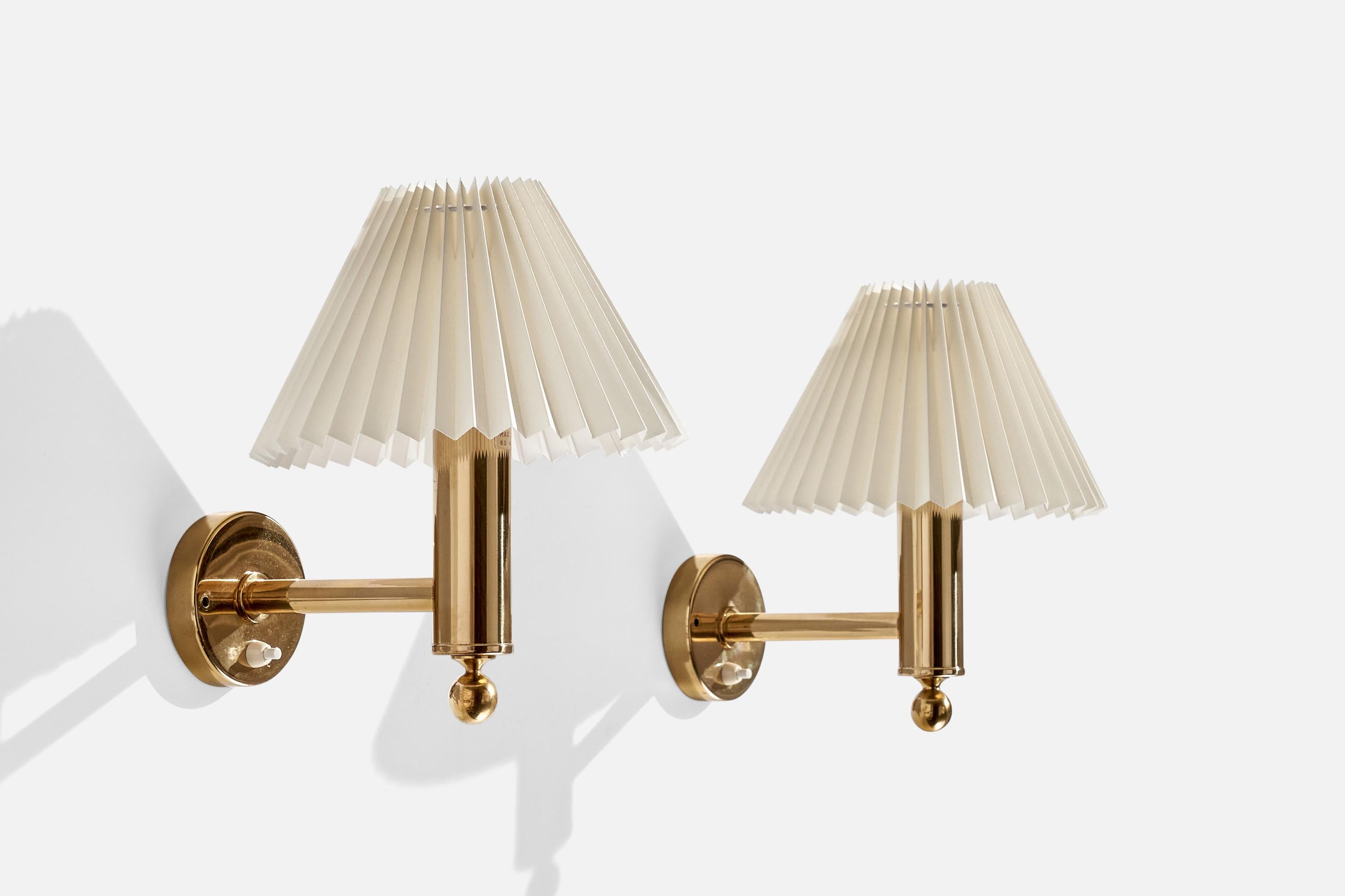 A pair of brass and paper wall lights produced by Bergboms, Sweden, c. 1970s.

Overall Dimensions (inches):  11.25” H x  9.5” W x  11.5“D
Back Plate Dimensions (Inches):  3.875” Diameter x .875” D
Bulb Specifications: E-26 Bulbs
Number of Sockets