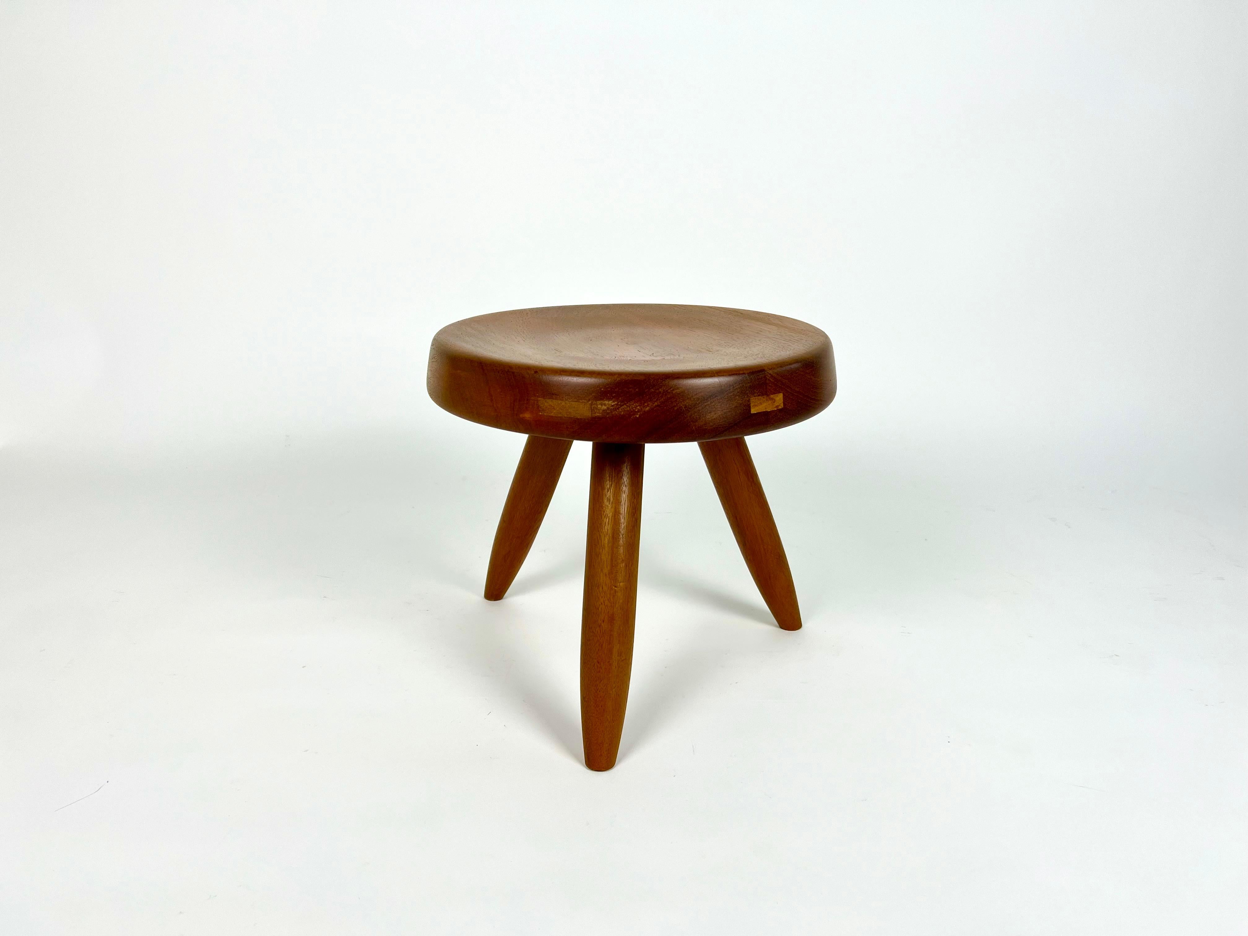 Charlotte Perriand 'Berger' low tripod stool in mahogany.

Sourced from a chalet estate sale in Meribel, Haute Savoie, France.

Well looked after with minor signs of use.
