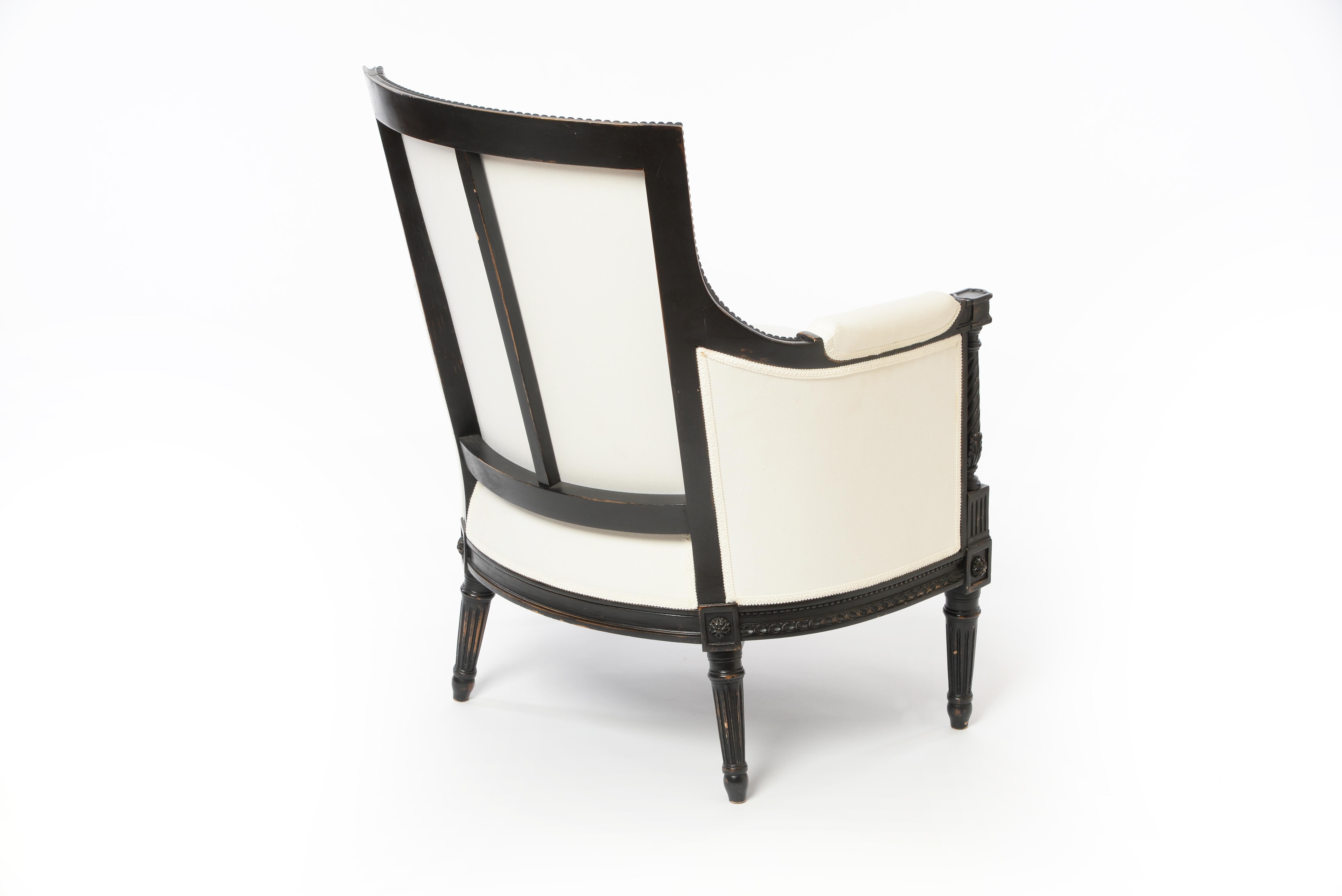 Very elegant bergere armchair handmade from beechwood. Beautiful wood decorations hand carved. Black paint with antique finish, white upholstery. 