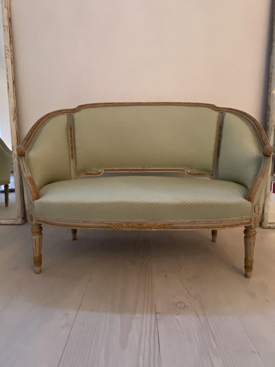 Lovely and comfortable old French Bergère sofa, in Louis Seize style with newer pistachio green upholstery. Bergére sofas date back to 18th century France, and are characterized by being slightly more compact pieces of seating furniture. Bergére