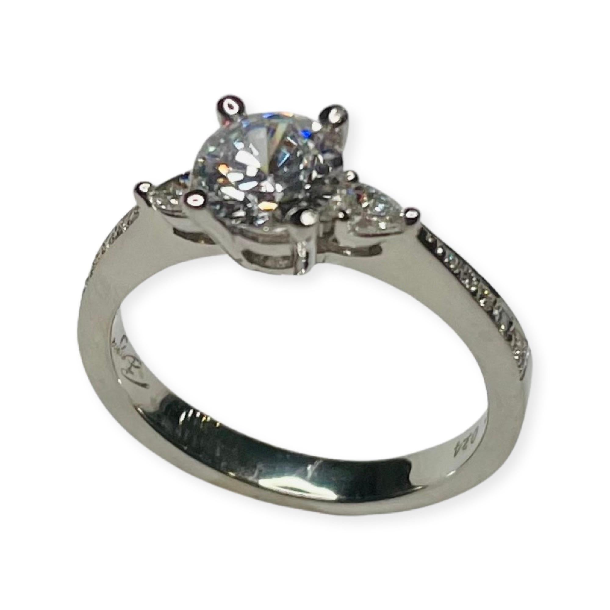 Bergio Platinum and Diamond Engagement Ring. There is an 8.0 mm cubic zirconia center. This is equivalent to a 2.0 carat diamond. There are 2 pear shaped diamonds, 3 prong set and have a total weight of 0.17 carats. There are 10 full cut round