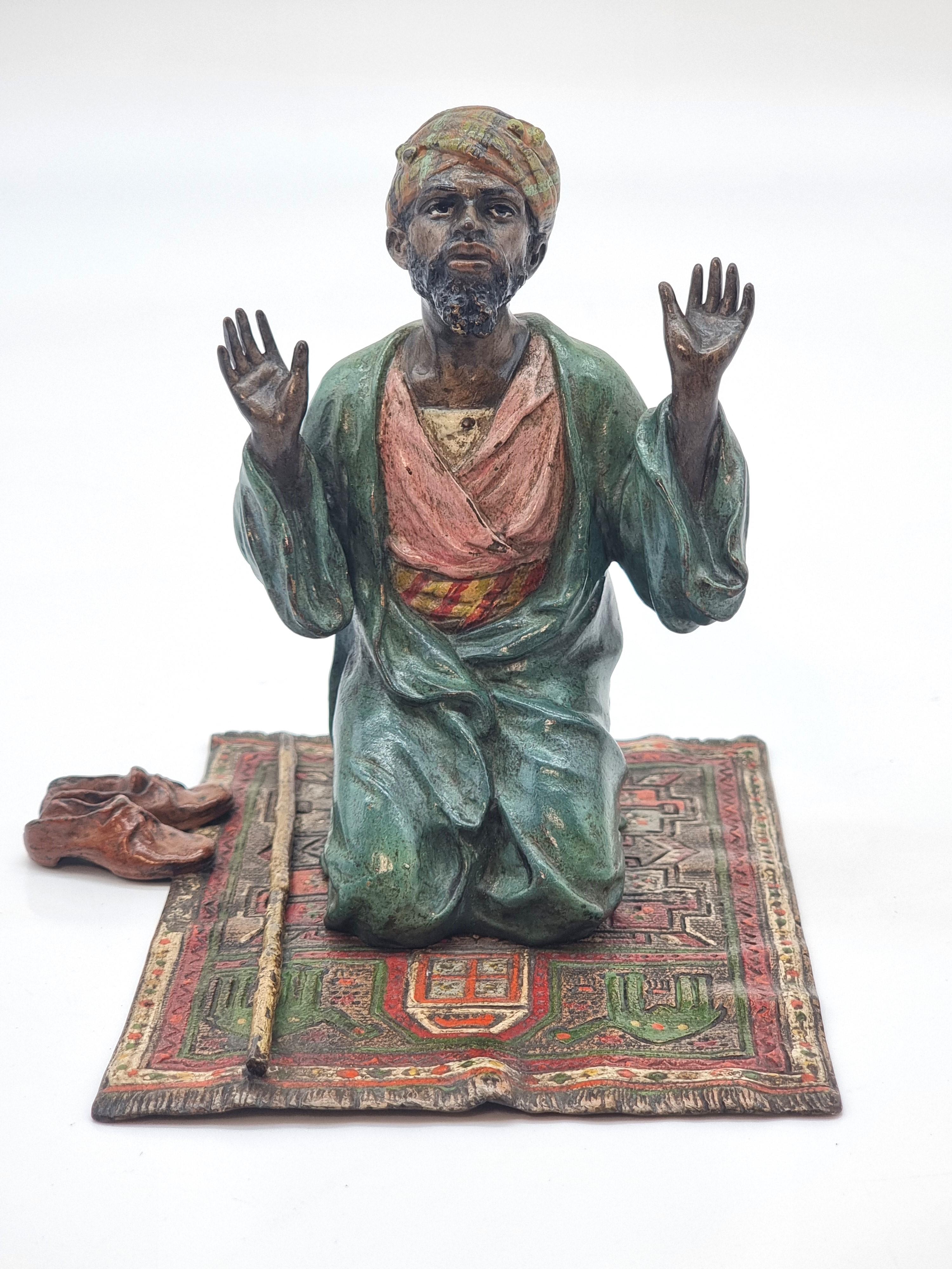 This larger scale fine cold painted bronze study is by the Austrian sculptor Franz Xavier Bergman.

It is in the Orientalist style and depicts a male Arab kneeling on a elaborate prayer rug with his arms and hands raised. He has removed his shoes