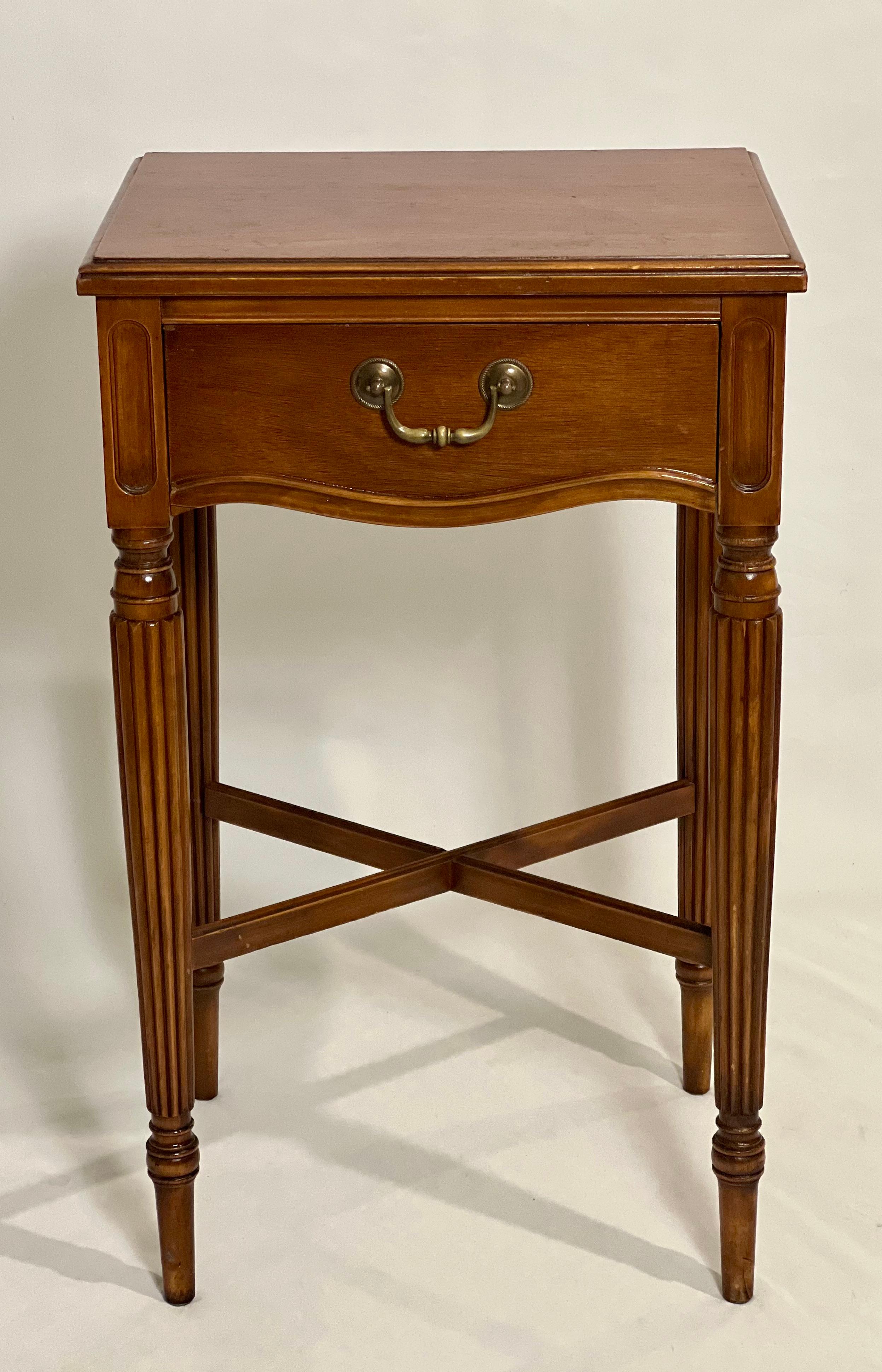 Louis XVI style walnut side table or stand by Berkey and Gay, c. 1920.

Stately table with a single dovetailed drawer with brass pull, fluted legs, cross stretcher and a finished back.  The table is beautifully crafted with fine details and has a
