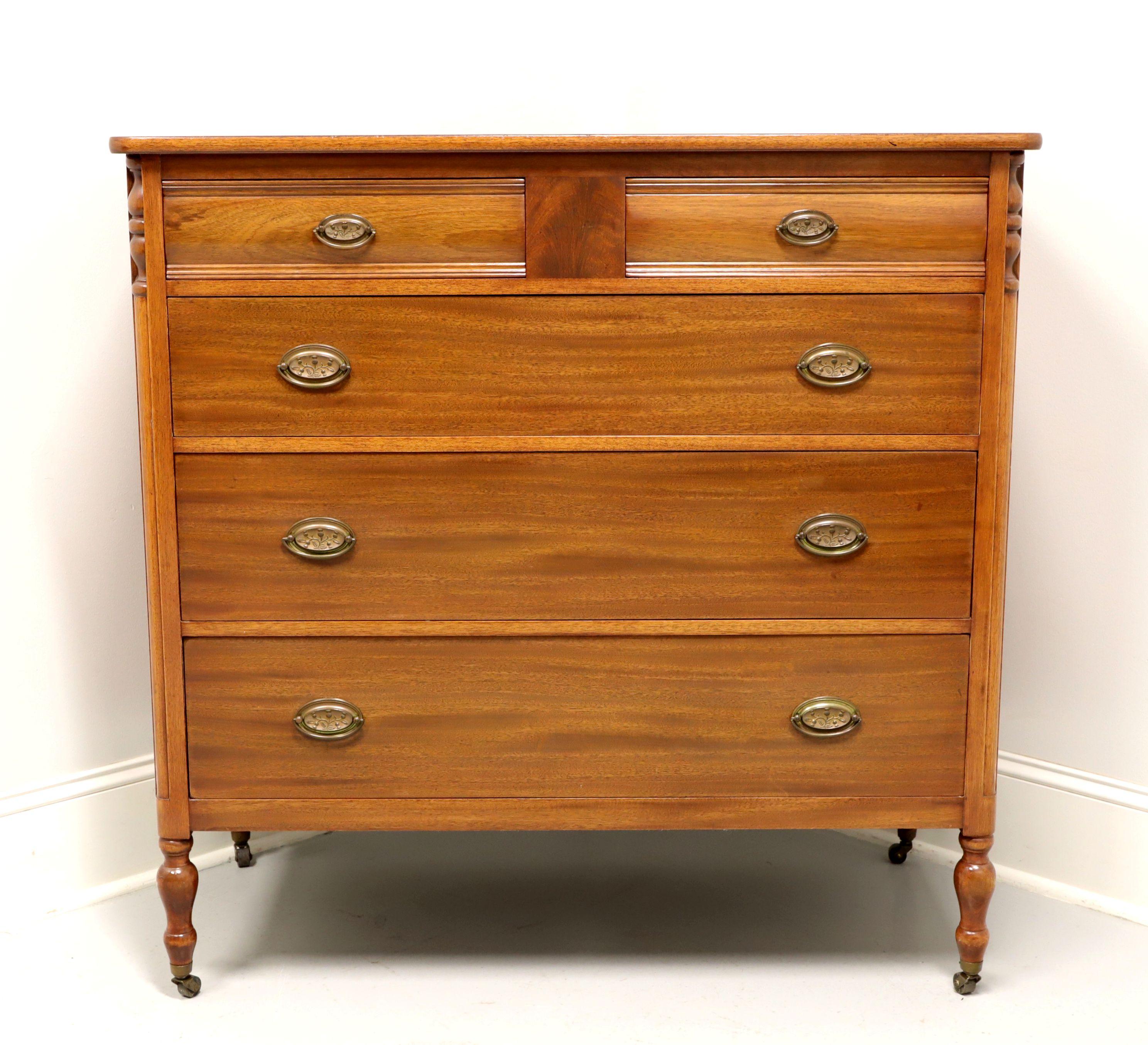 A Sheraton style two over three chest of drawers by Berkey & Gay, of Grand Rapids, Michigan, USA. Solid mahogany with a lighter finish, brass hardware, decoratively carved corners and turned feet with brass casters. Features two smaller over three