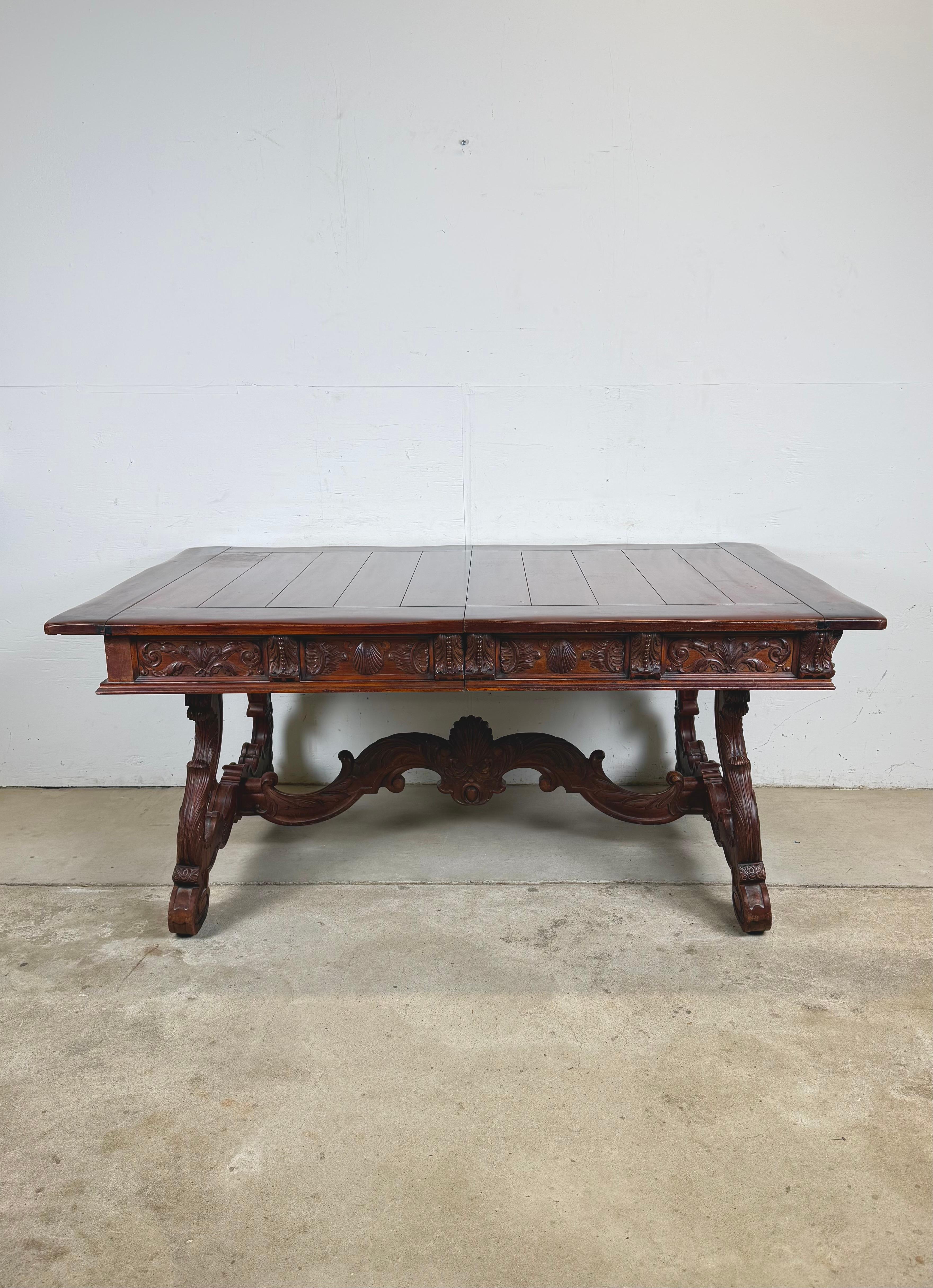 Produced by the renowned American firm Berkey & Gay, this dining table exemplifies the Spanish Revival movement, which drew inspiration from European Renaissance and Iberian design traditions. The piece blends ornamental carving with architectural