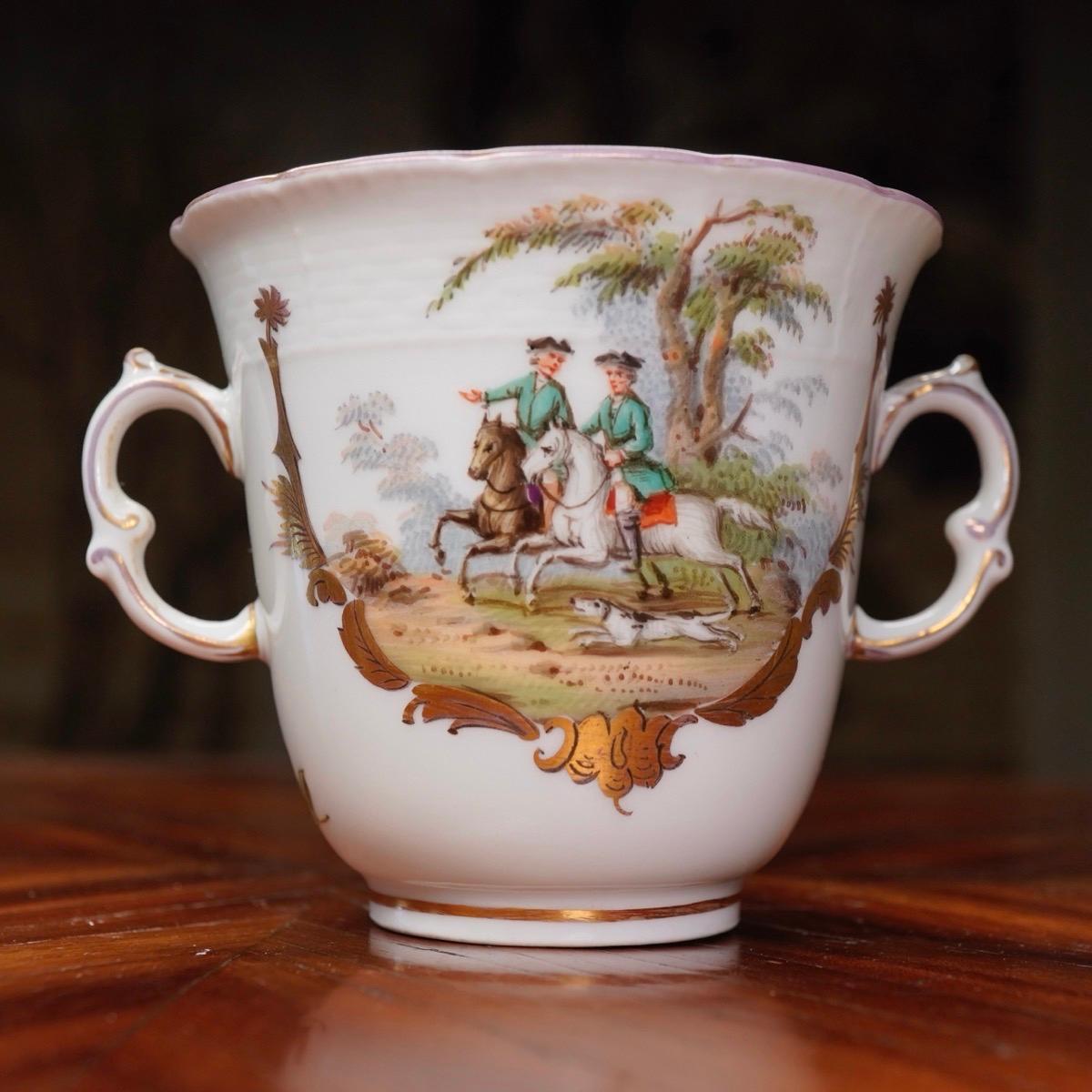 Berlin chocolate cup, with twin handles, well painted with hunt scenes within gilt rococo panels in the Meissen style.
Blue sceptre mark, circa 1780.