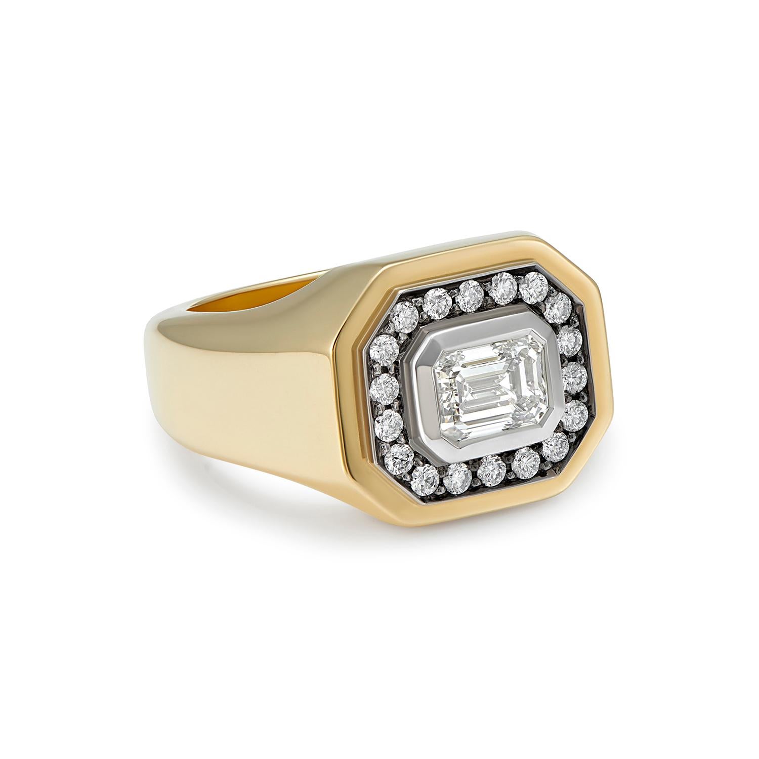 0.90ct Emerald cut Diamond (GIA)
0.51ct White Diamonds
18k Yellow Gold 

This fabulously chunky statement ring is set with an emerald cut diamond weighing 0.90 carat. We have used black rhodium around the halo of diamonds weighing 0.51 carats.
Total