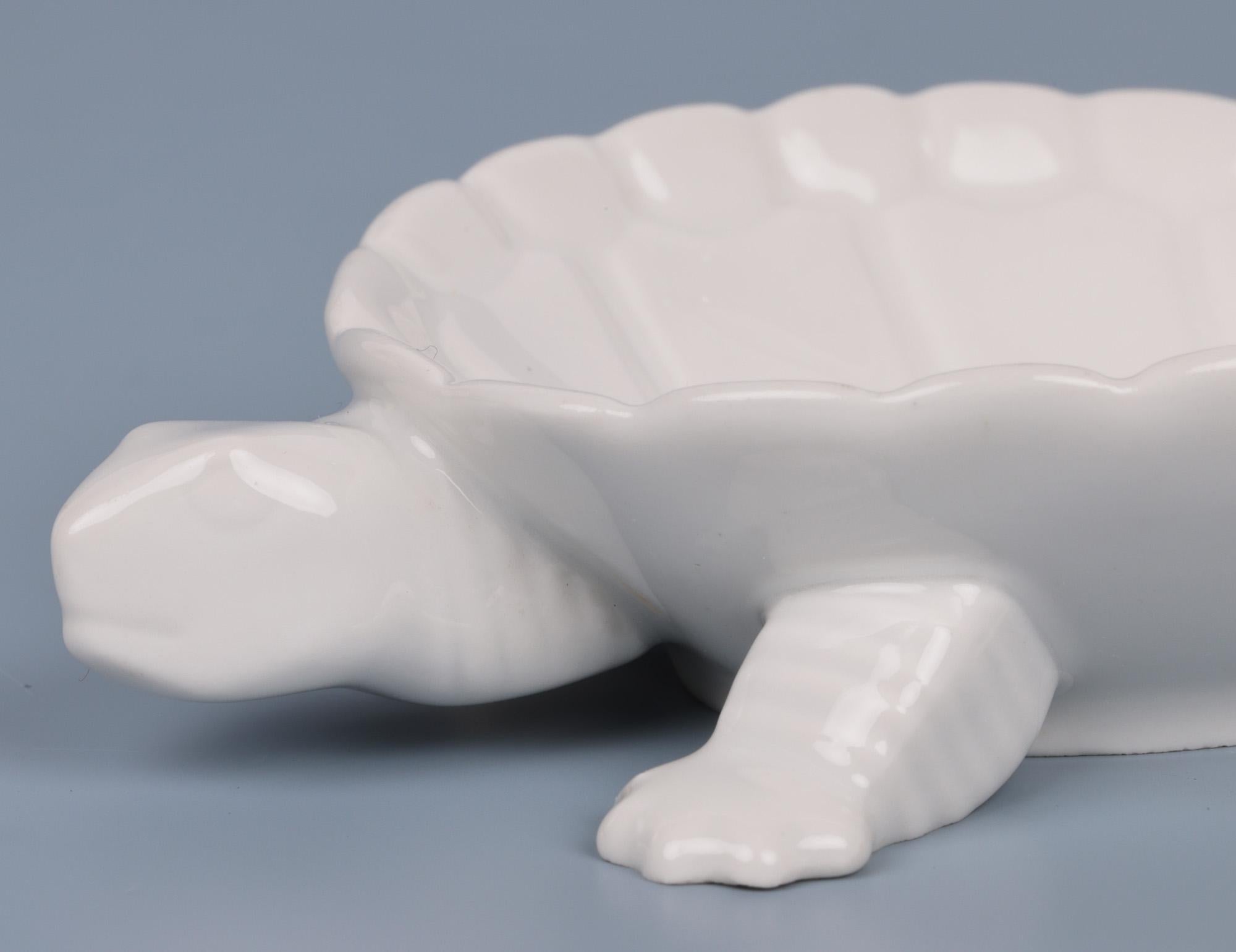 A delightful German mid-century porcelain pin dish modelled as a tortoise by renowned makers Berlin and believed to date between 1945 and 1962. The dish is modelled as small tortoise resting on four molded legs and feet with a small tail and head