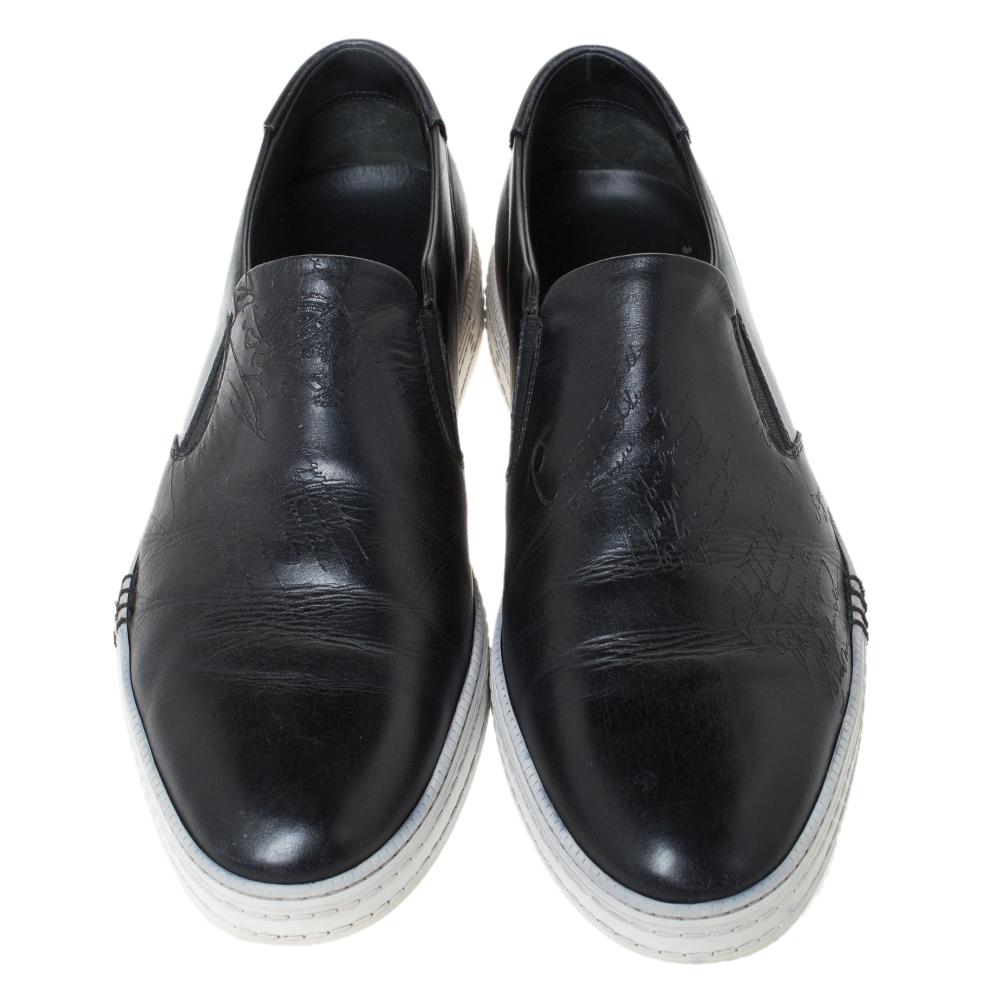 These Berluti sneakers are simple yet stylish. They've been crafted from black leather and designed with embossed details, round toes and rubber soles. These sneakers are just perfect to ace one's casual look.

