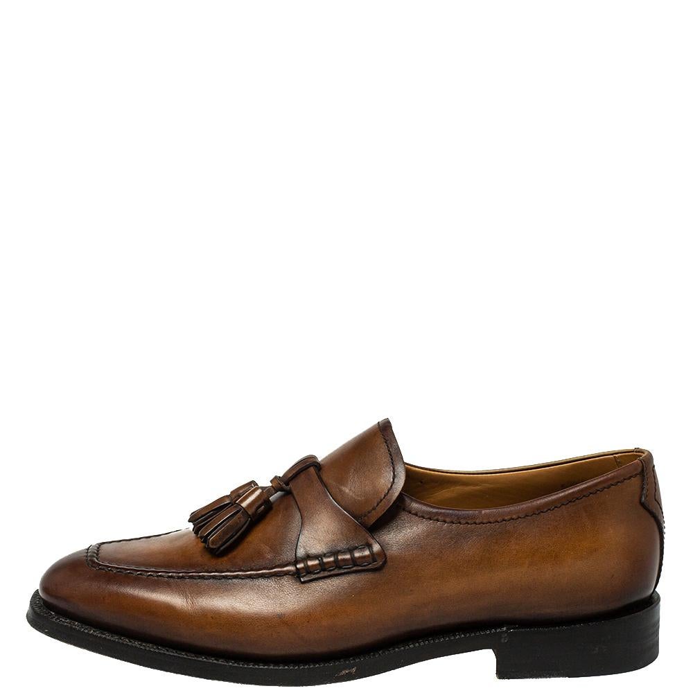 Right on style and comfort, this pair of loafers by Berluti will make a great addition to your shoe collection. They've been crafted from leather in brown and styled with tassels on the vamps. Snug leather insoles and an elegant finish beautifully